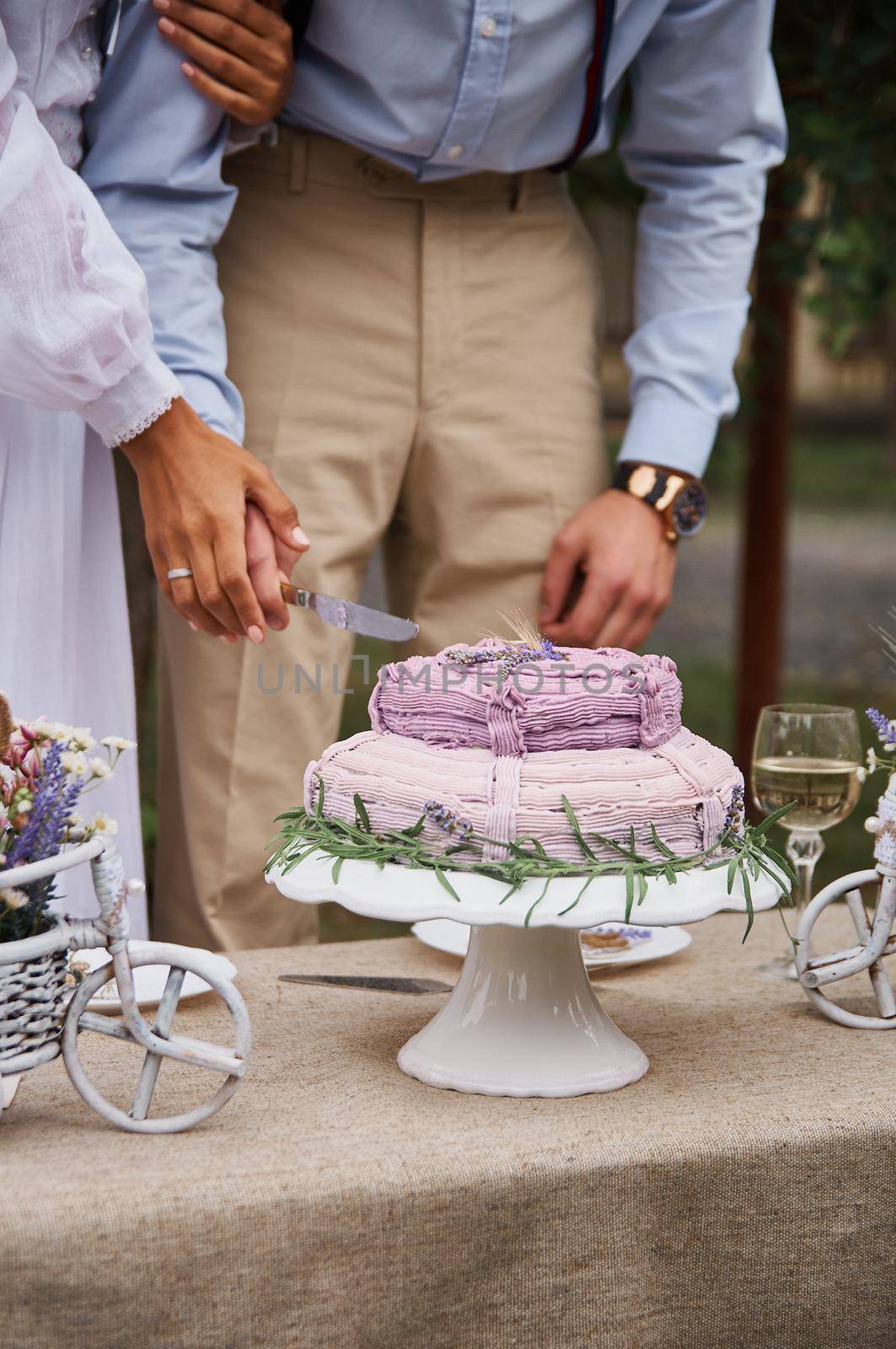 butter cake in rustic style on the holiday table cut the bride and groom