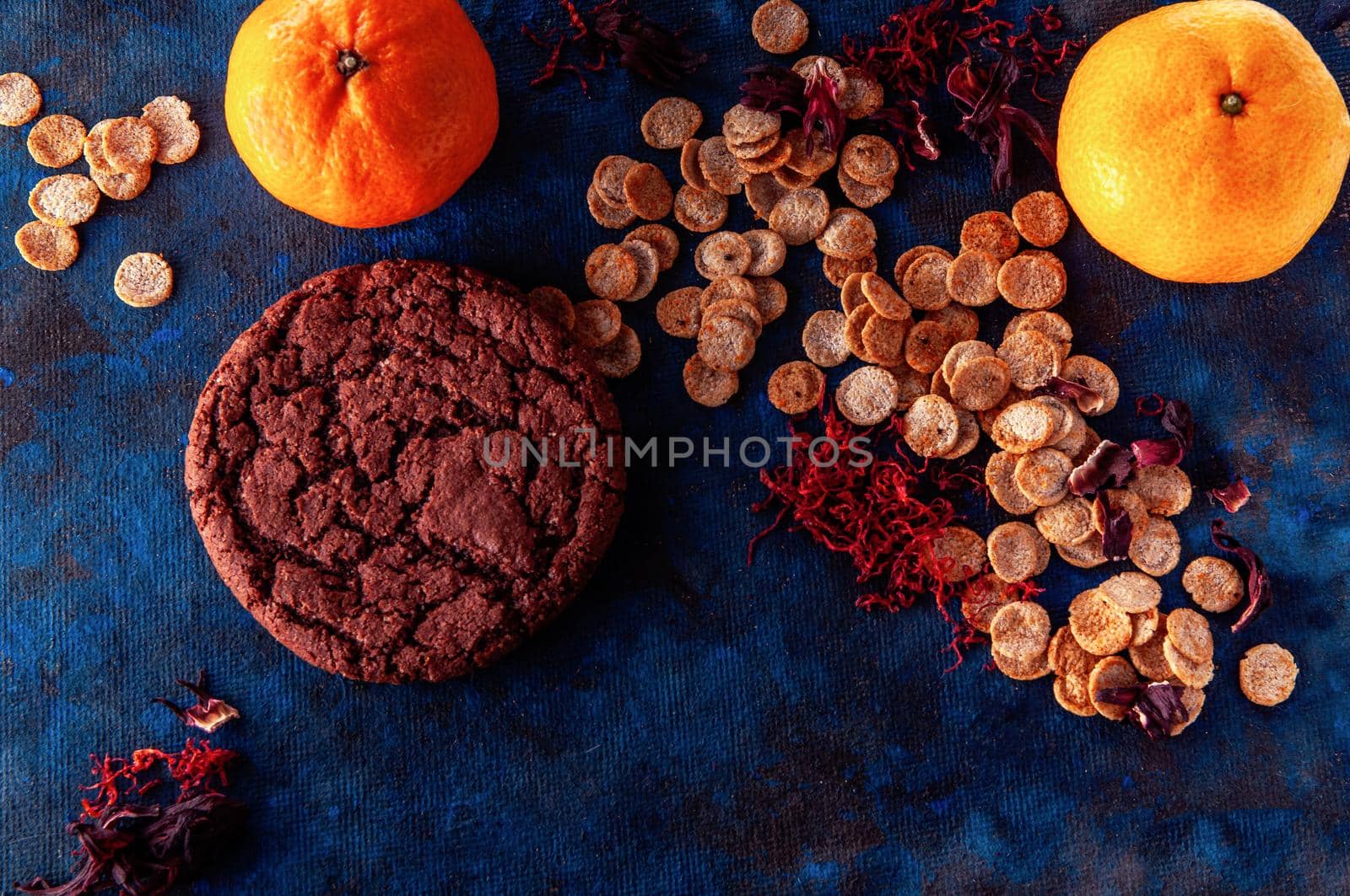 still life on a blue background with american dry crispy cookies and tangerines