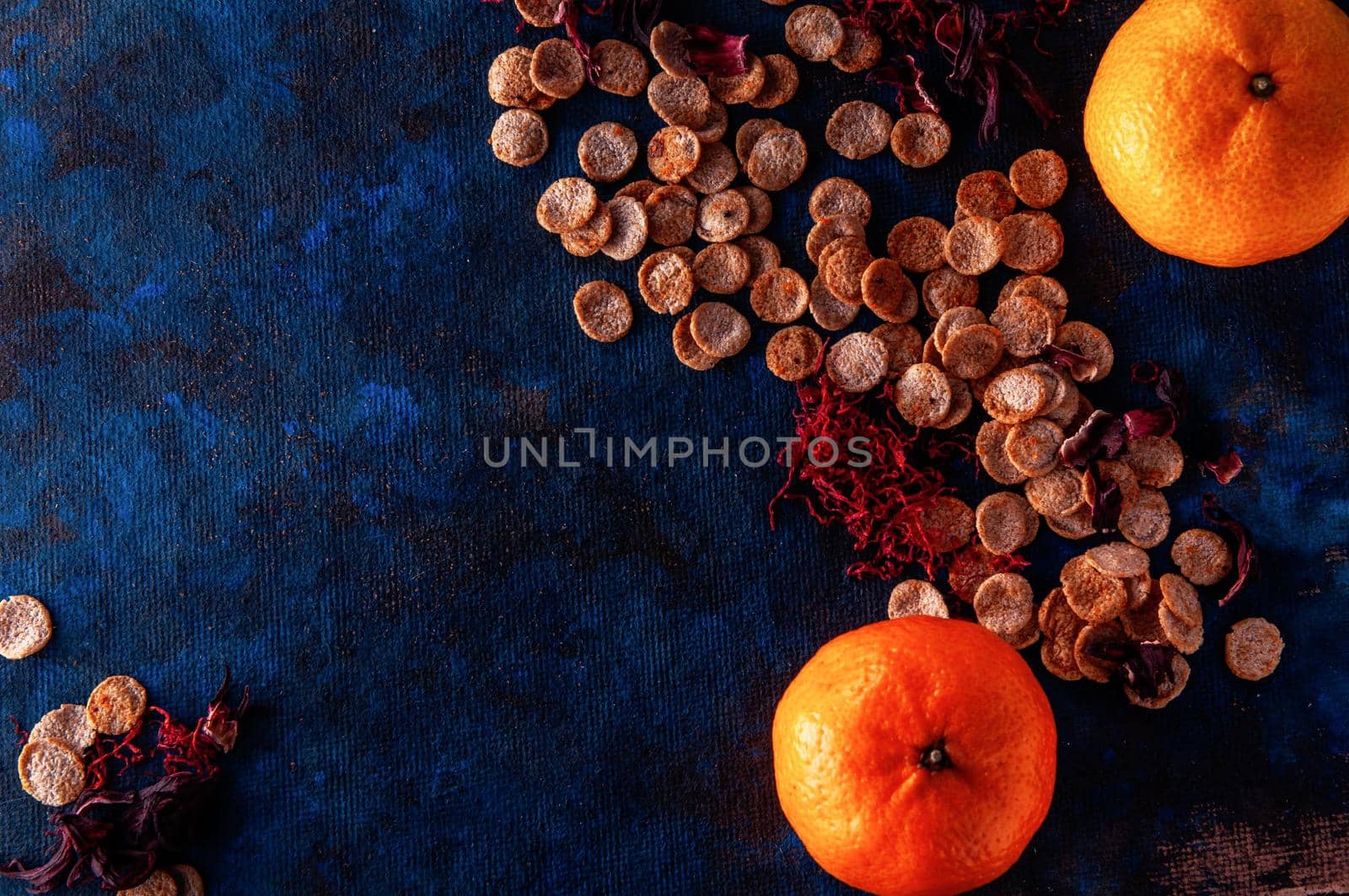 still life on a blue background with american dry crispy cookies and tangerines