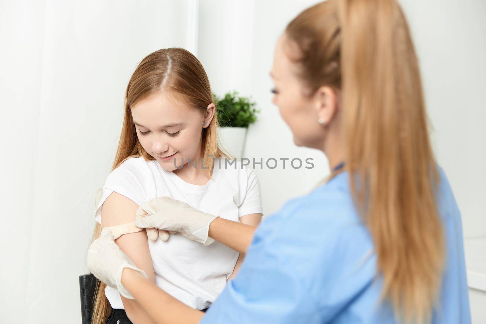 female doctor next to girl vaccination health treatment. High quality photo