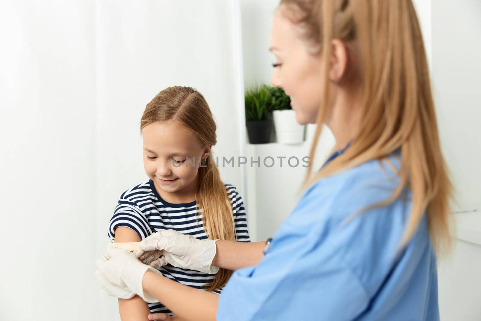 female doctor in blue coat medicine treatment girls covid vaccination by SHOTPRIME