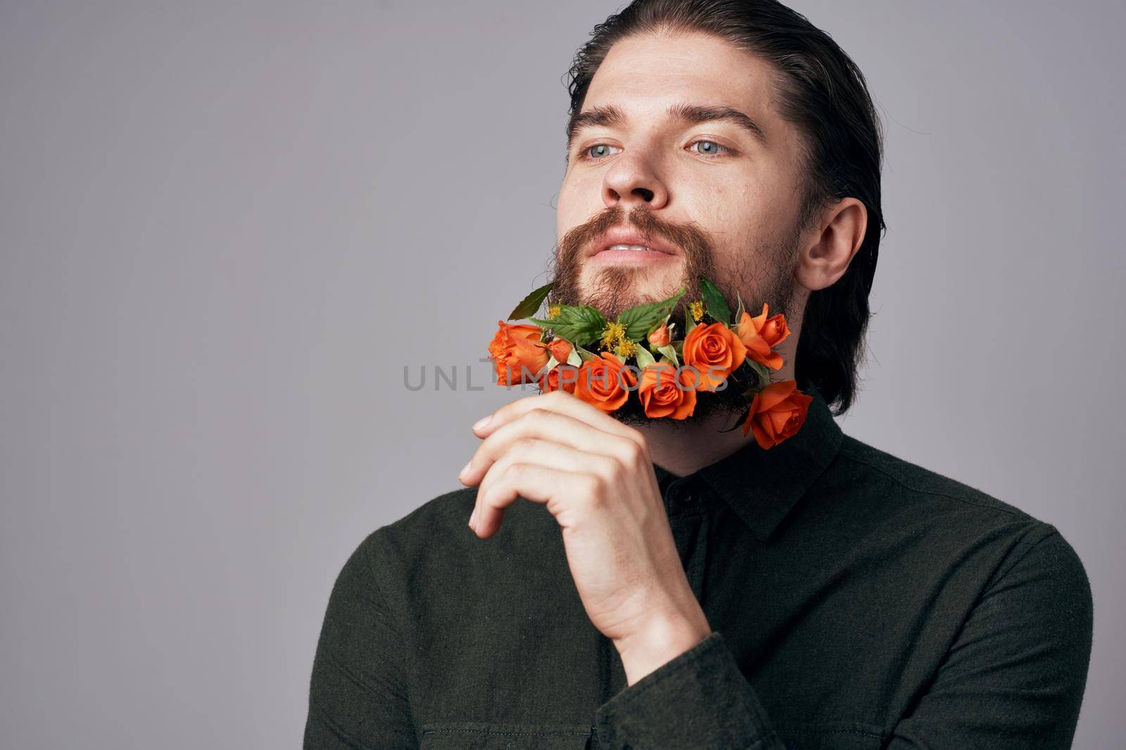 Cute elegant man in a black shirt flowers in a beard decoration romance gray background by SHOTPRIME