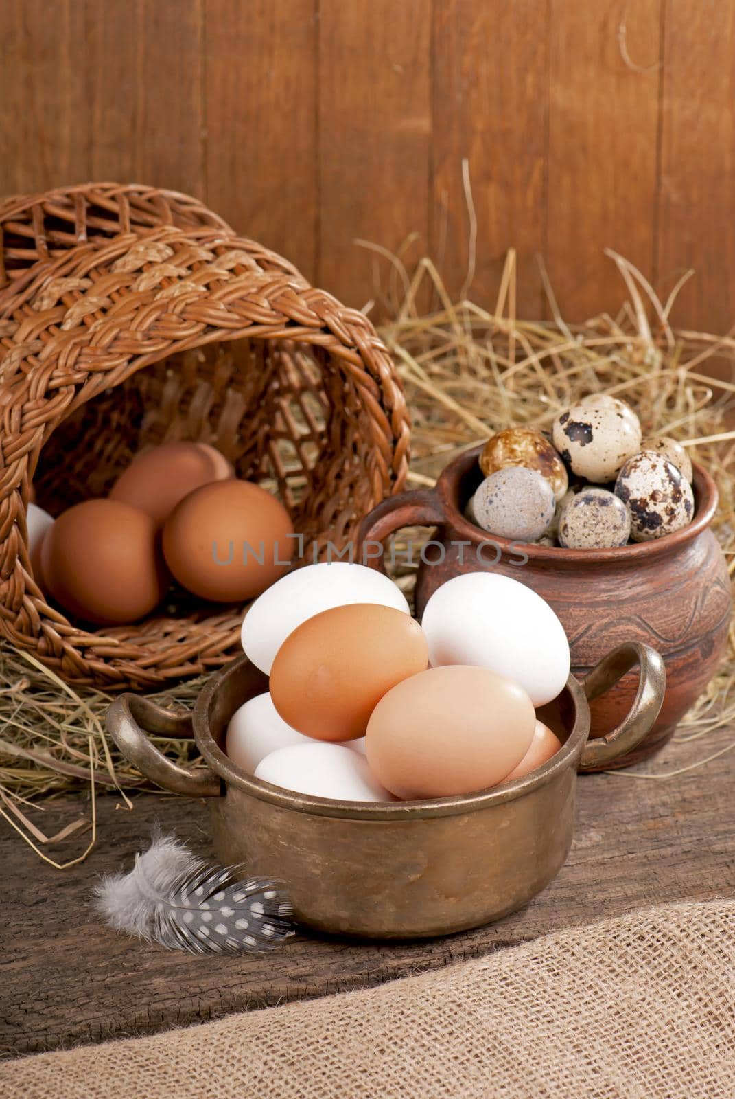 Chicken eggs in basket on wooden background by aprilphoto