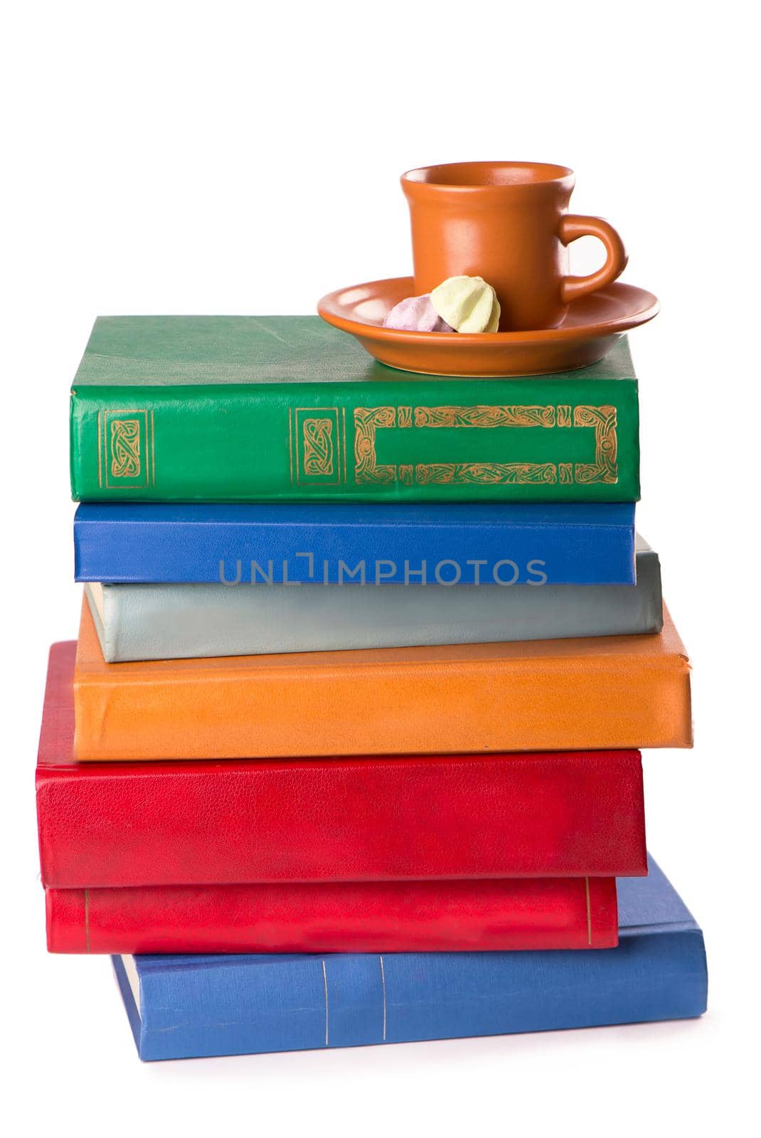 stack of Old books and a cup of coffee isolated on white by aprilphoto