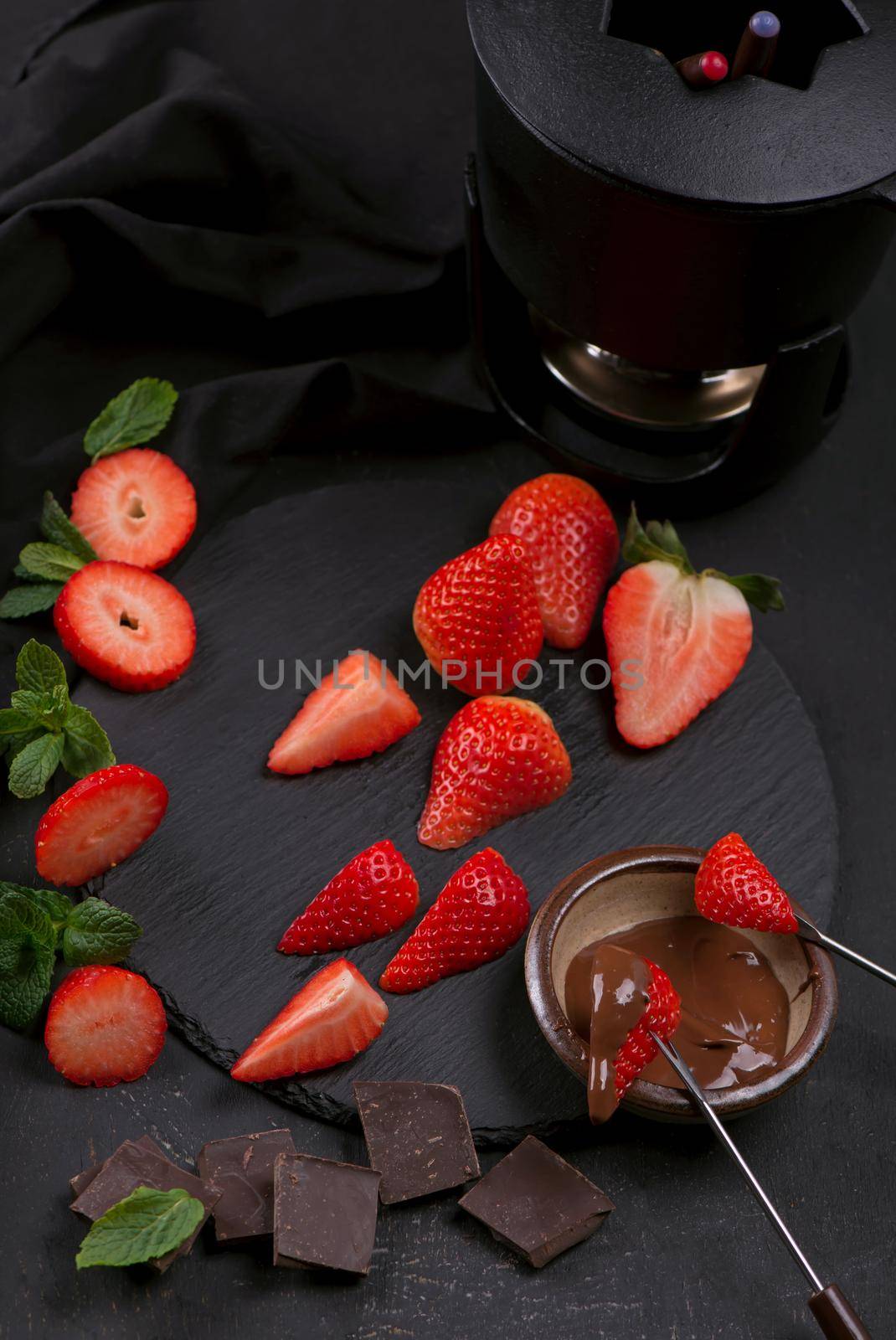 Composition with chocolate covered strawberries on grey background