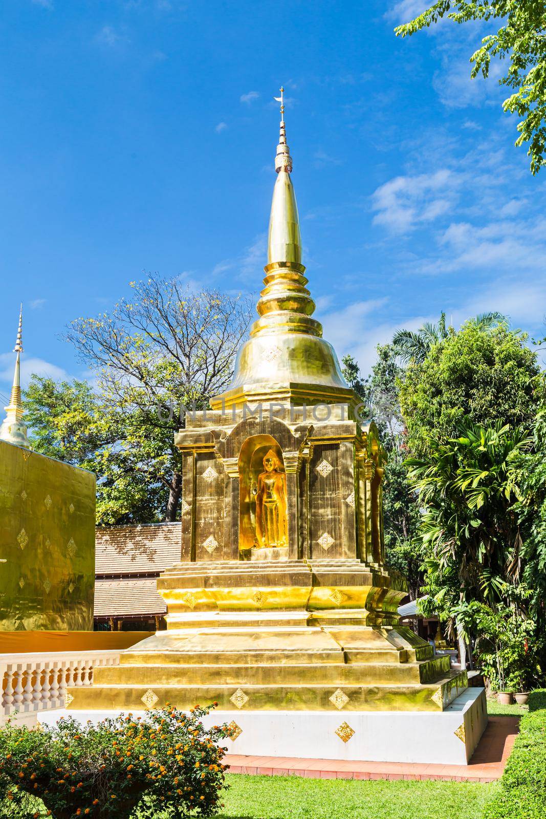 Beautiful golden pagoda with blue sky at Wat Phra Singh in Chiang Mai, Thailand.