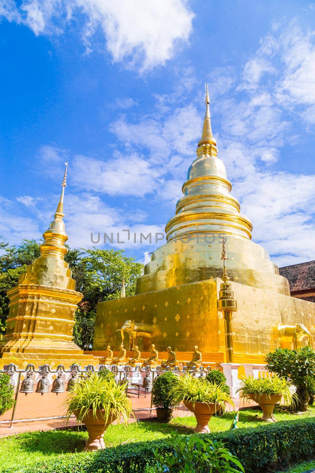 Beautiful golden pagoda with blue sky at Wat Phra Singh in Chiang Mai, Thailand.