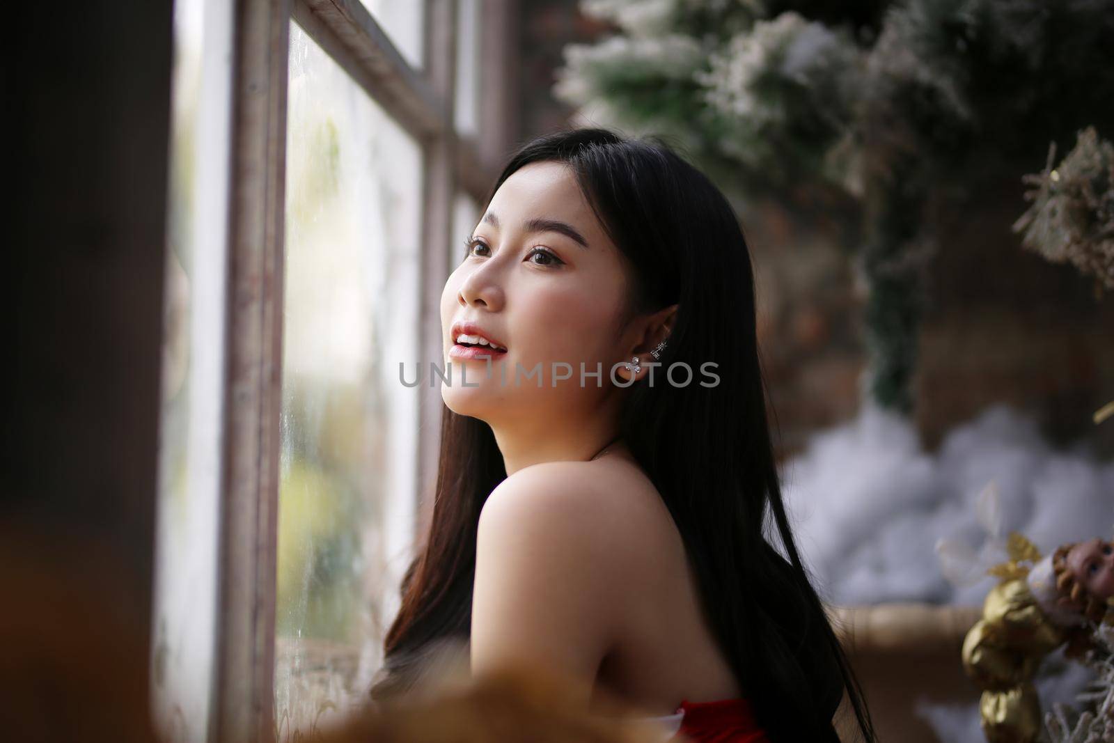 Young woman in red santa costume, Girl celebrates New Year 2021 in winter. Shopping black friday sale concept by chuanchai