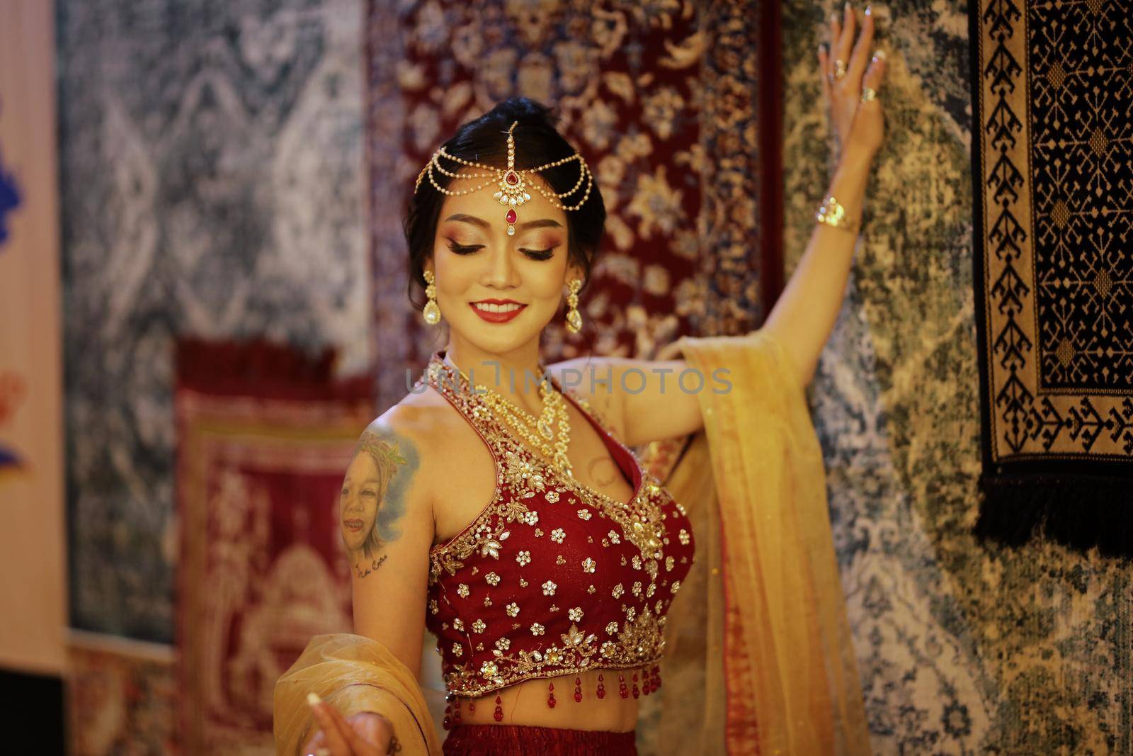 Portrait of beautiful indian girl . Young hindu woman model in sari and kundan jewelry . Traditional India costume lehenga choli . Eastern or Arabic culture.