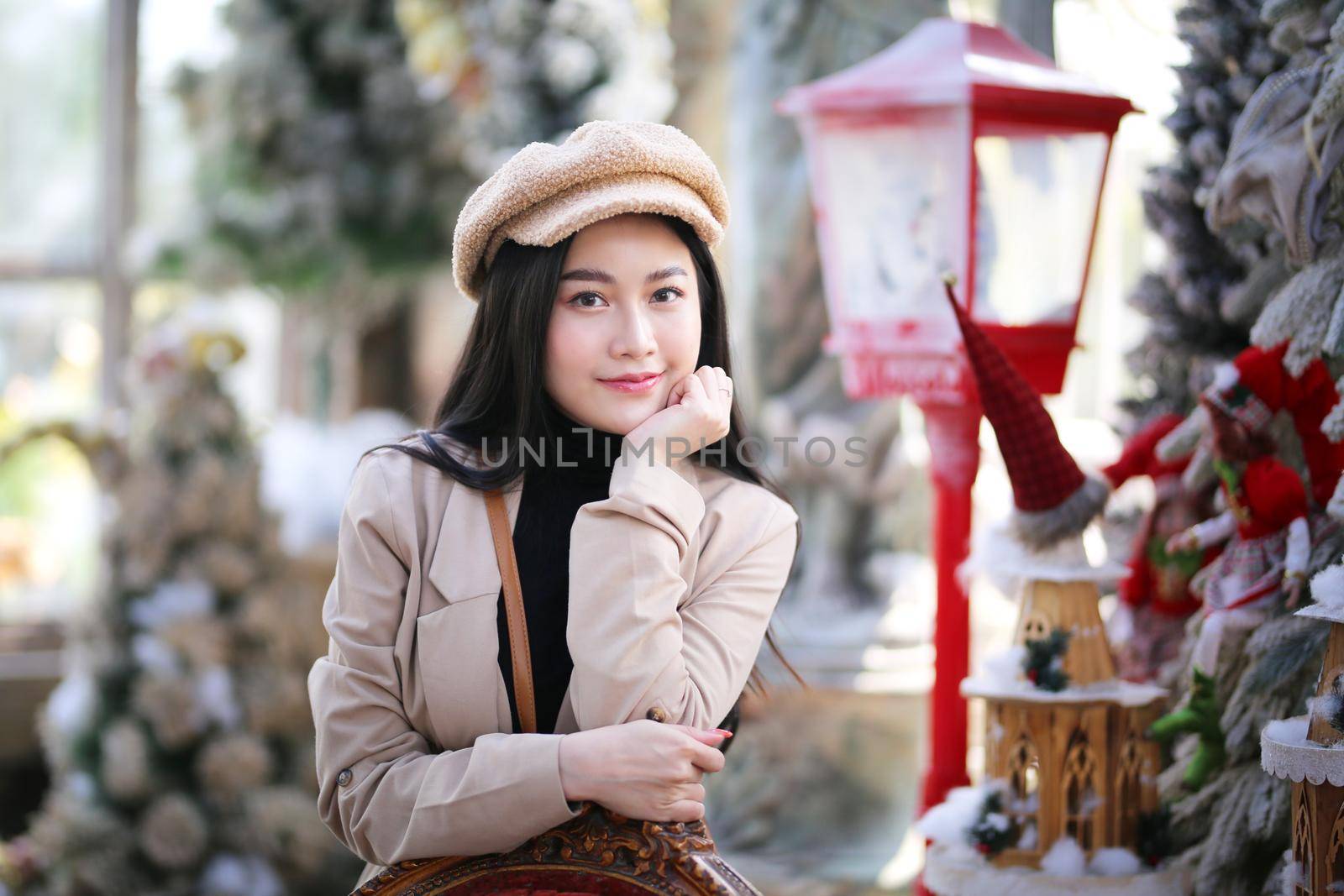  Portrait of young beautiful woman in winter clothes. while posing on snow background. Outdoor close-up photo of female model with romantic smile chilling in park in winter.