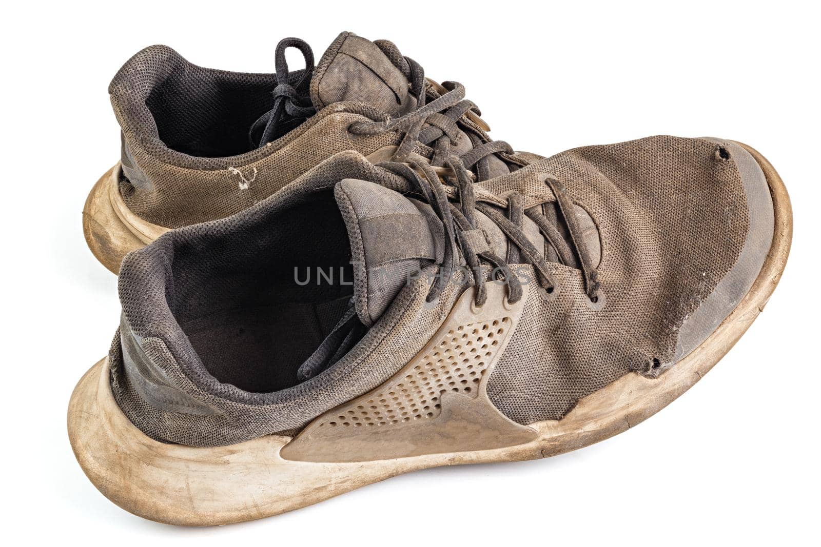 pair of weared dirty sneakers isolated on white background.