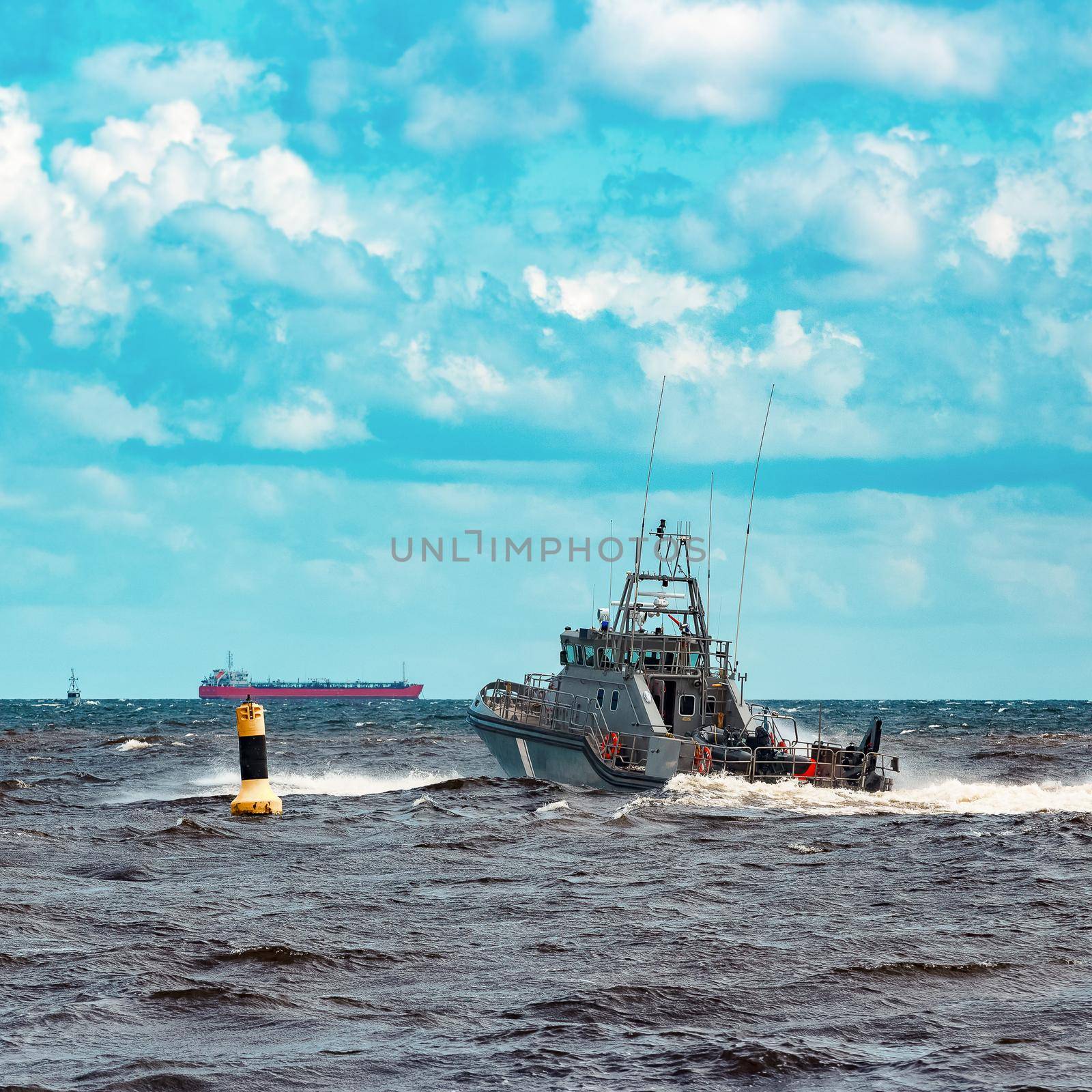 Grey military ship sailing at Baltic sea. Border guard service