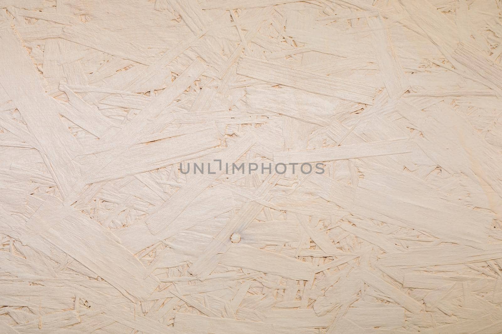 Fragments of glued boards from wood chips. Chipboard beige, wood texture. Wood recycling concept