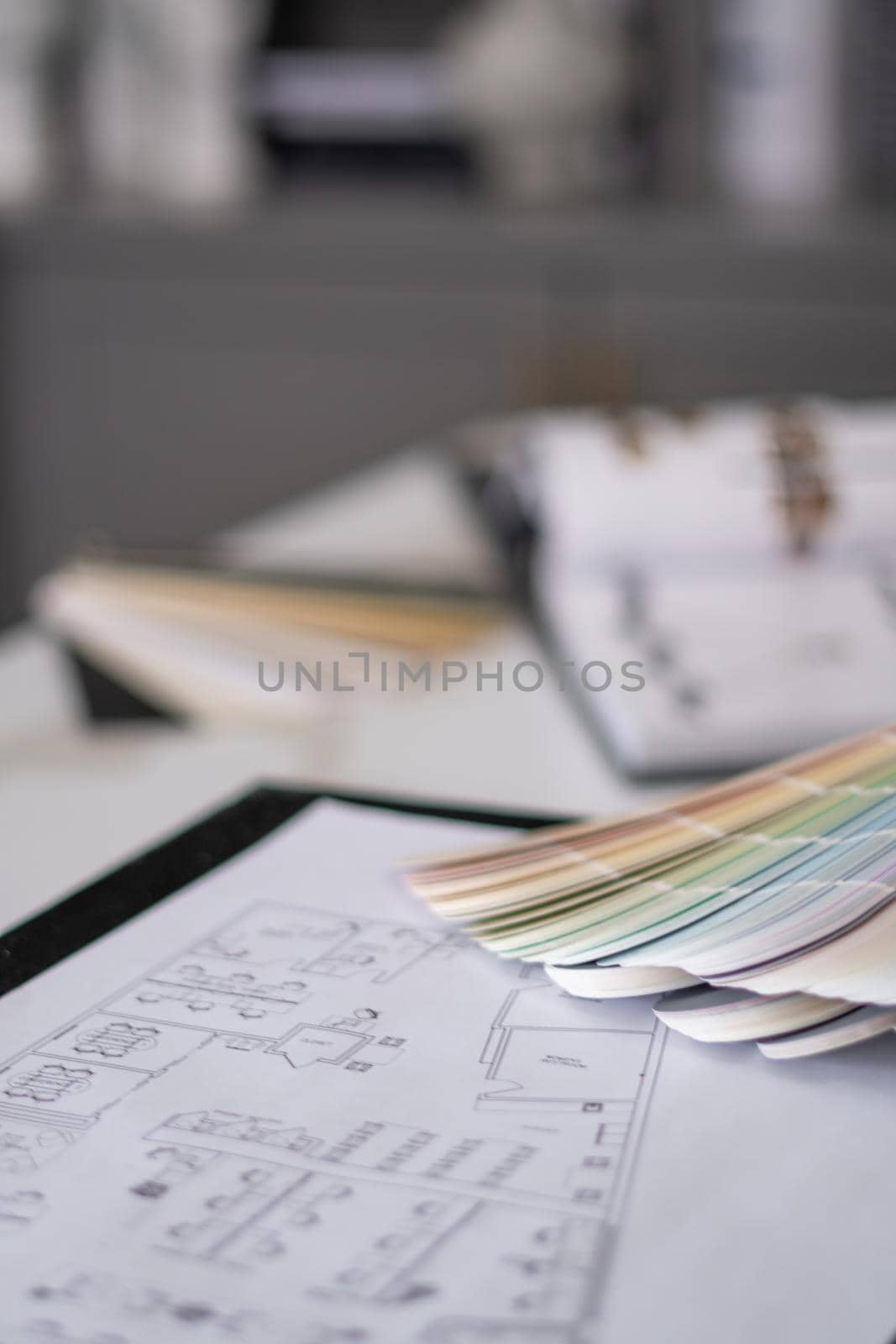 Interior designer's working table, an architectural plan of the house, a color palette. by Bonandbon