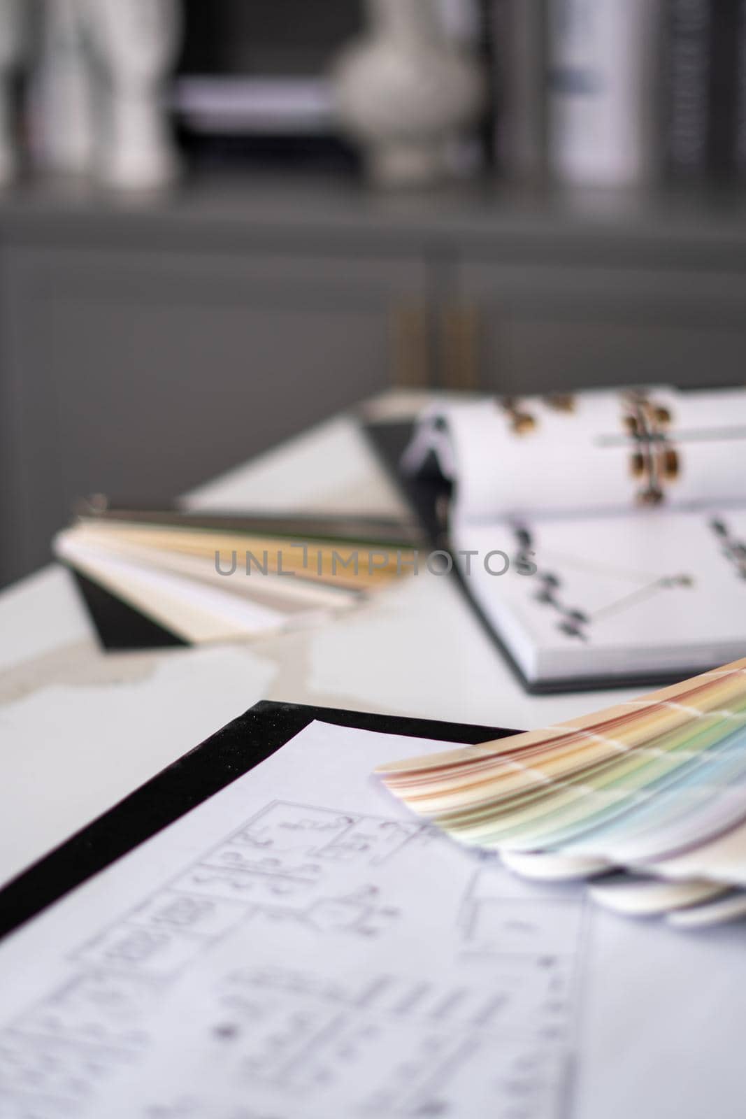 Interior designer's working table, an architectural plan of the house, a color palette. by Bonandbon