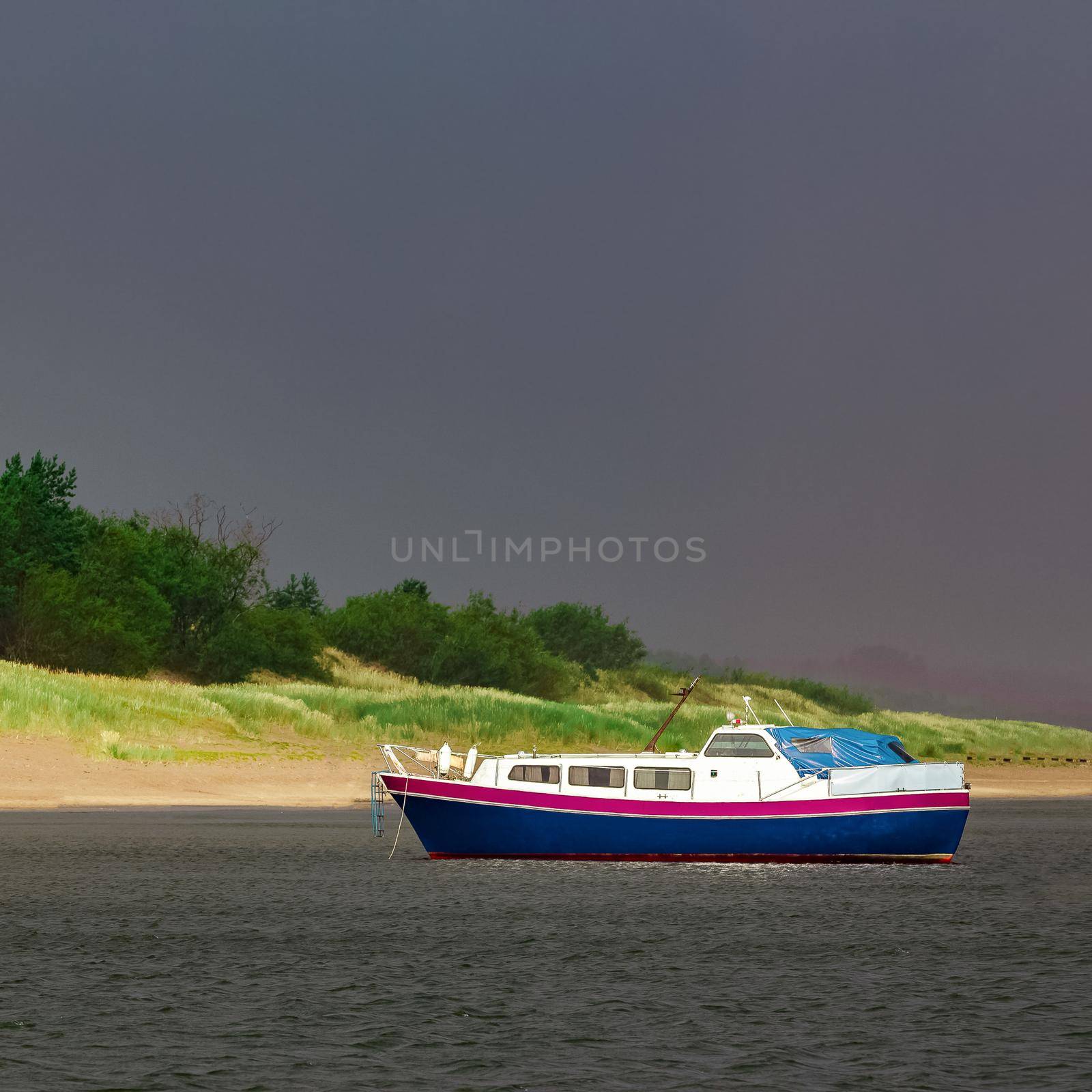 Small blue passenger ship moored at Baltic sea bay