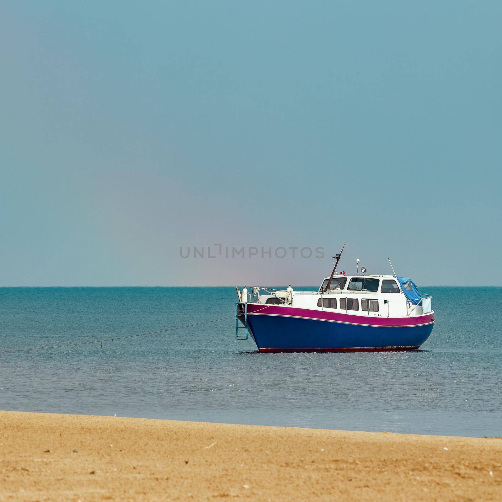 Small blue passenger ship moored at Baltic sea bay