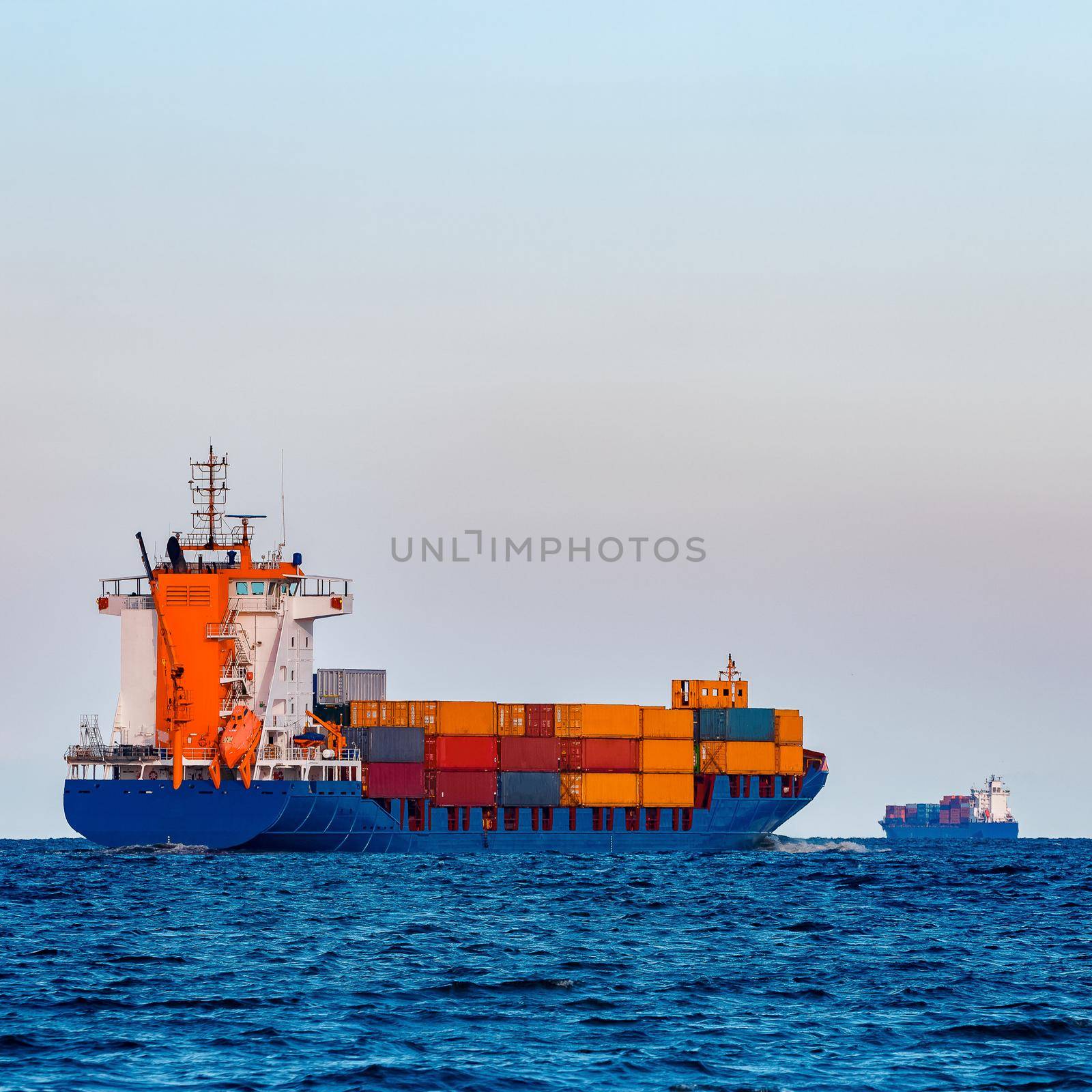 Blue container ship. Global logistics and merchandise transfer