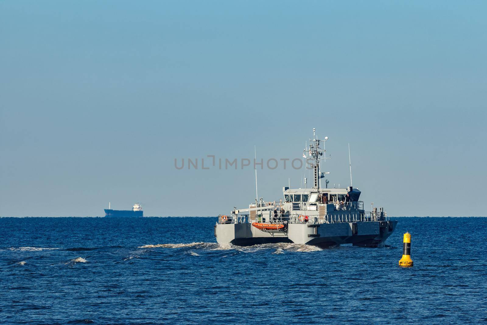 Small grey military ship moving from Baltic sea