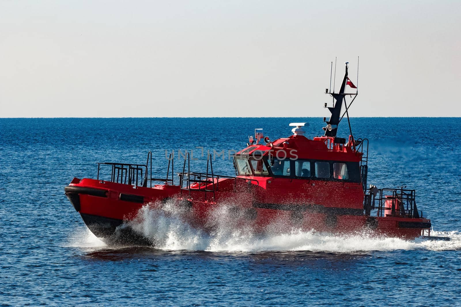 Red pilot ship moving from the Baltic sea