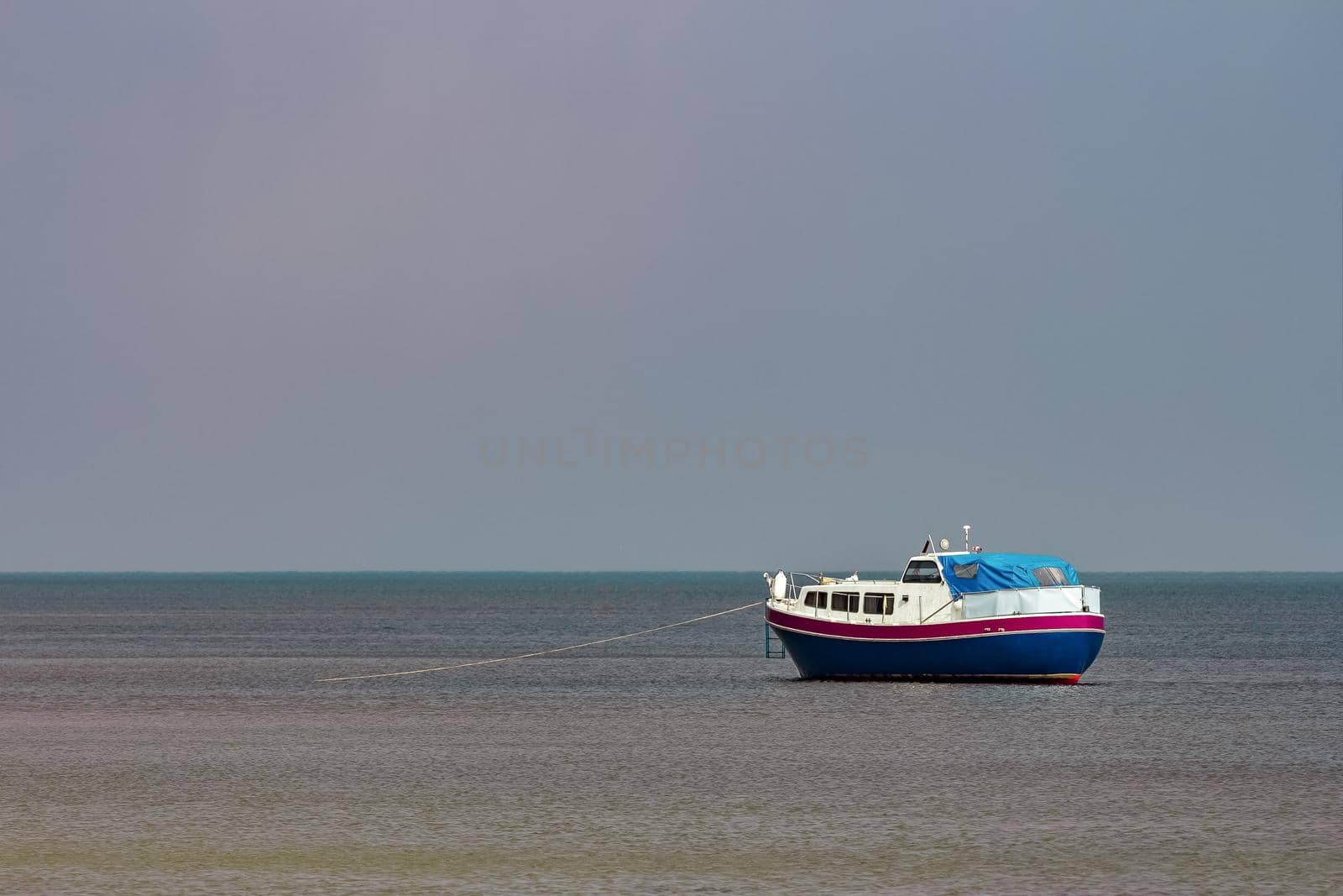 Small blue passenger ship moored at Baltic sea bay