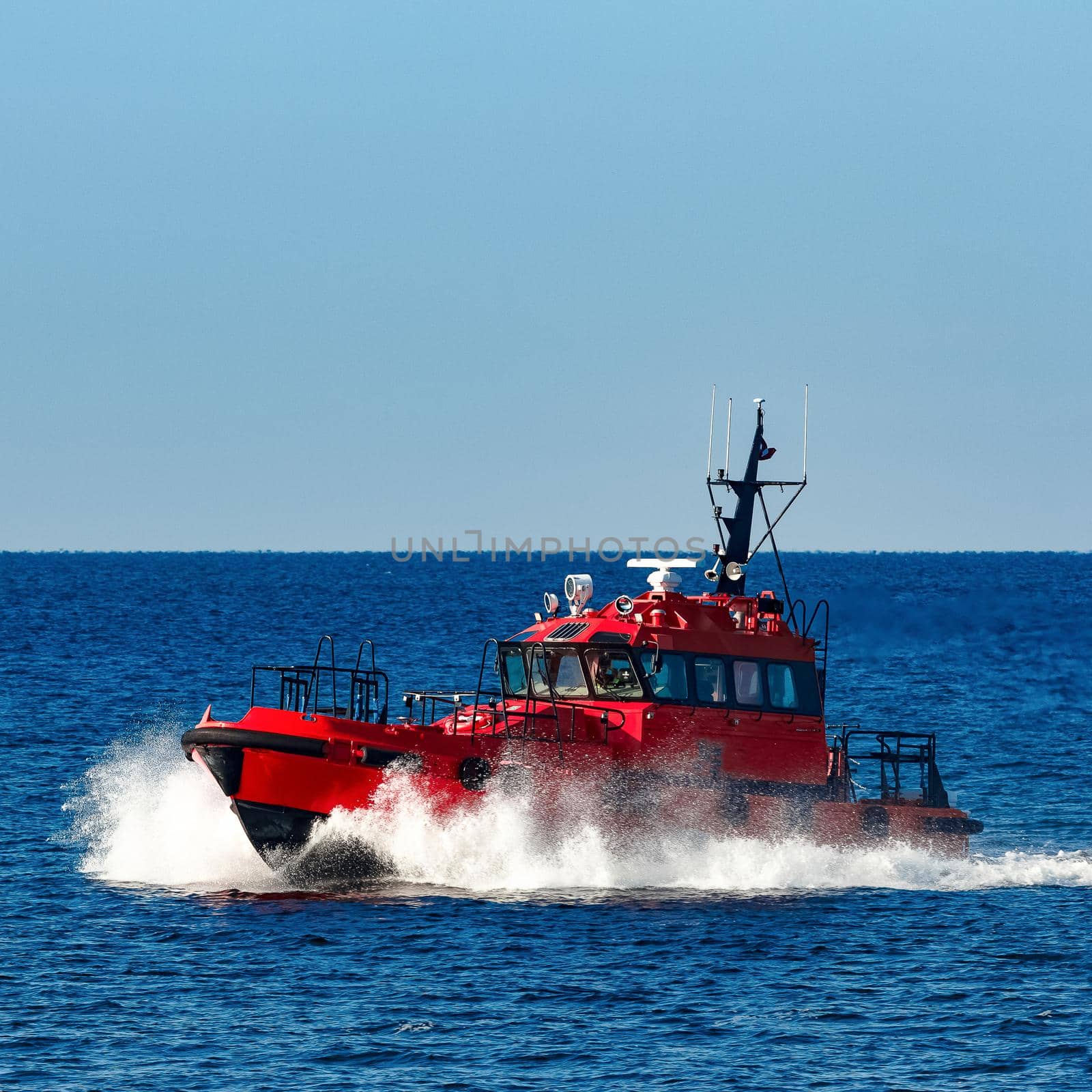 Red pilot ship moving from the Baltic sea