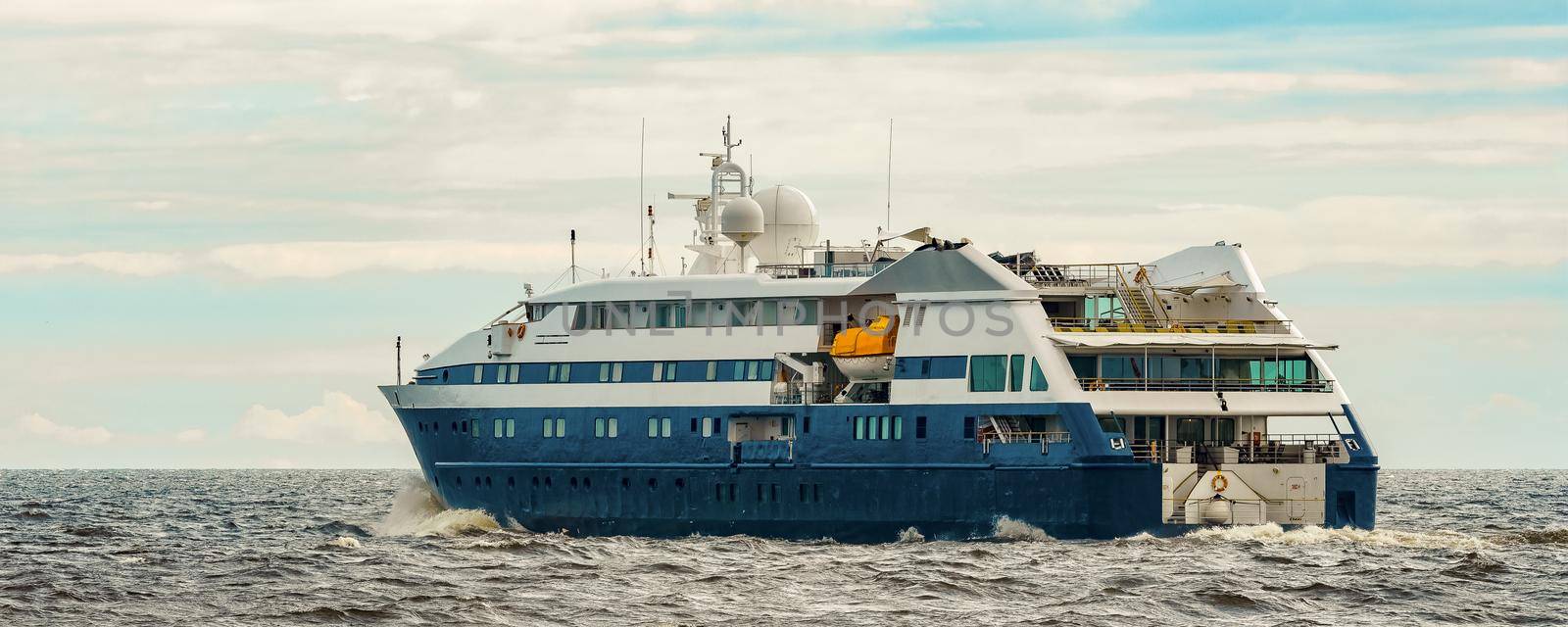 Small blue passenger ship sailing in Baltic sea. Spa services