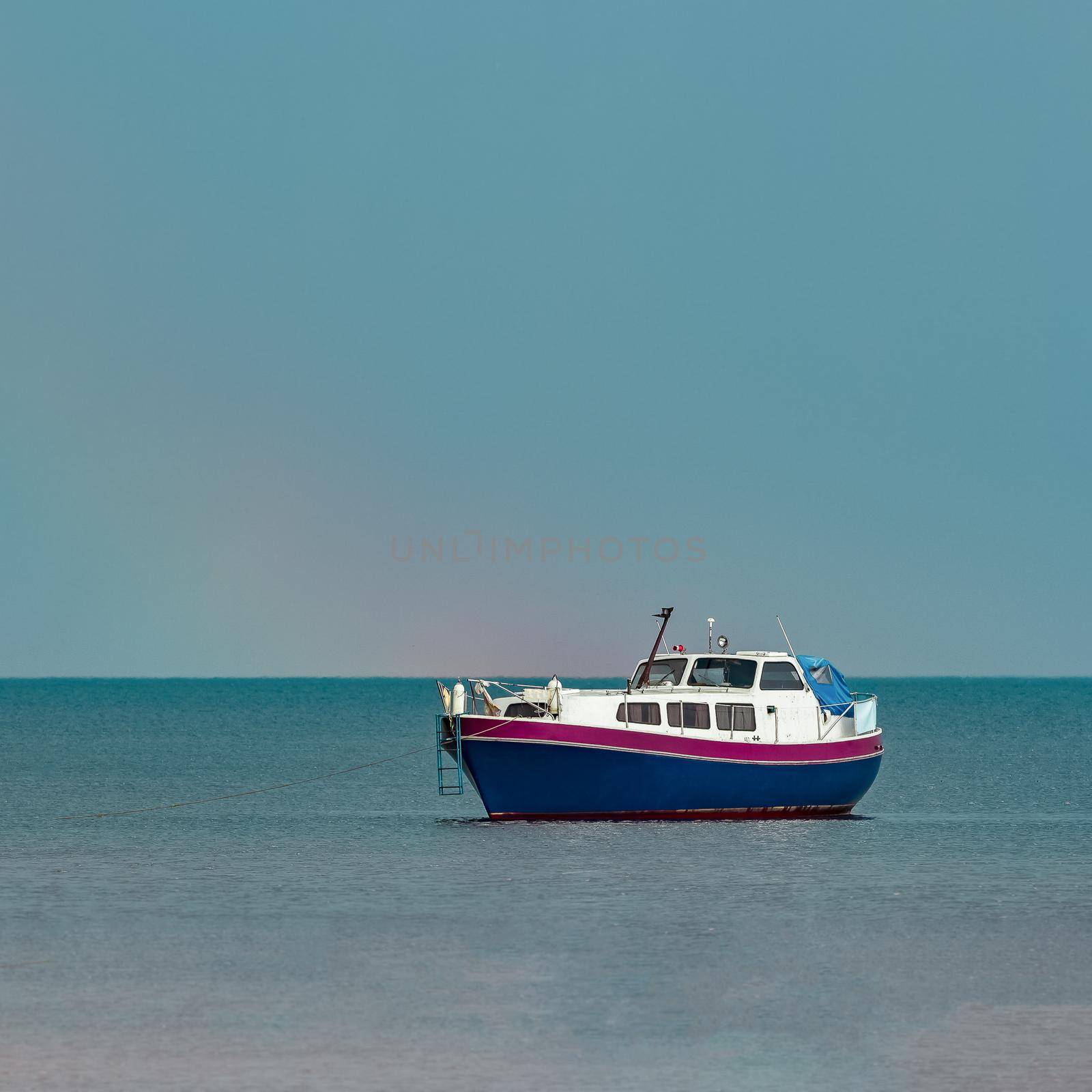 Small blue passenger ship moored at Baltic sea bay