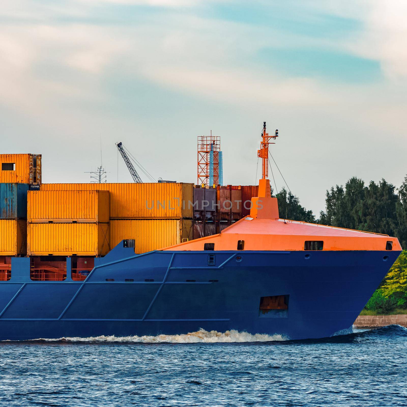 Blue container ship. Global logistics and merchandise transfer