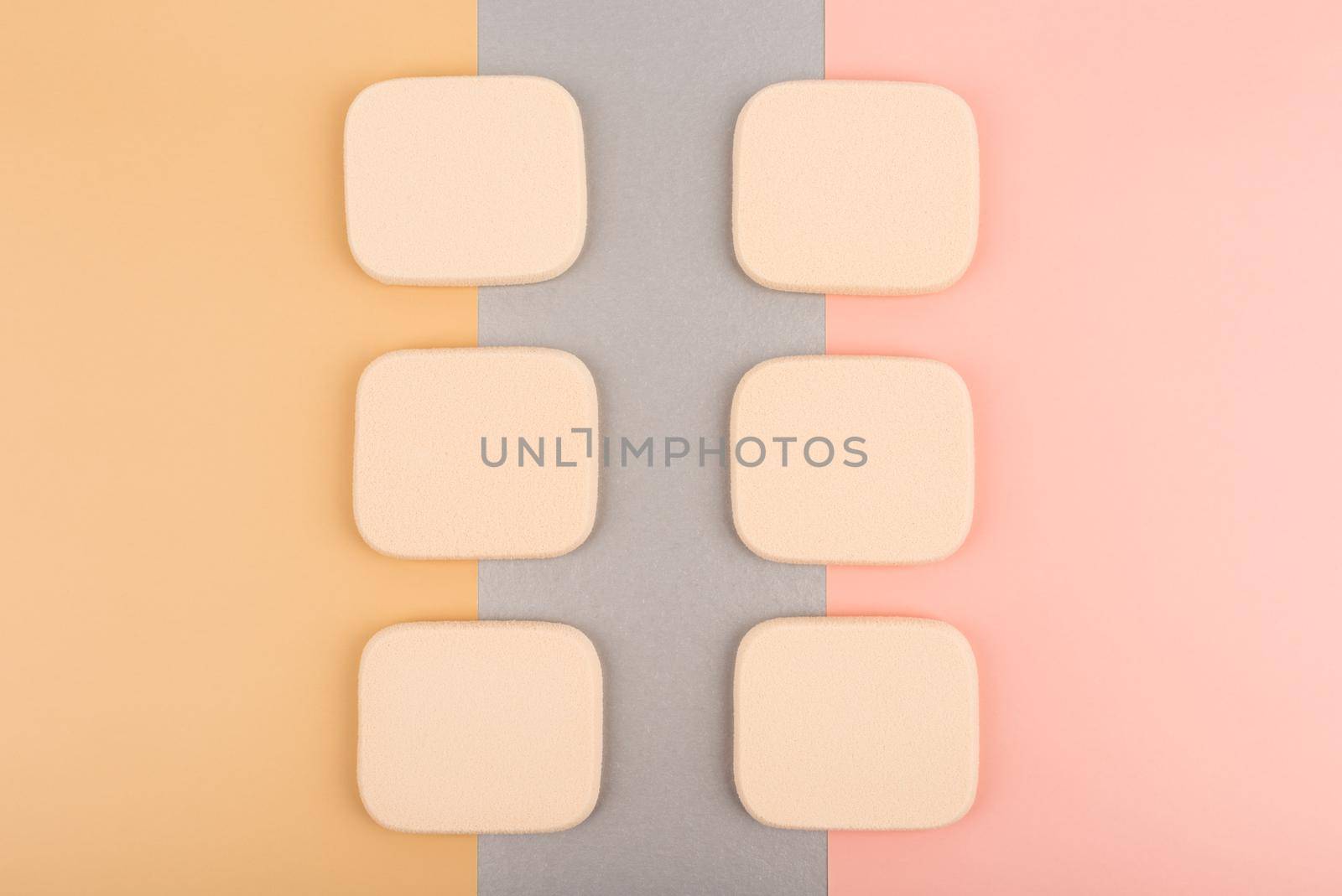 Flat lay with make up sponges against colored pink, silver and beige background by Senorina_Irina