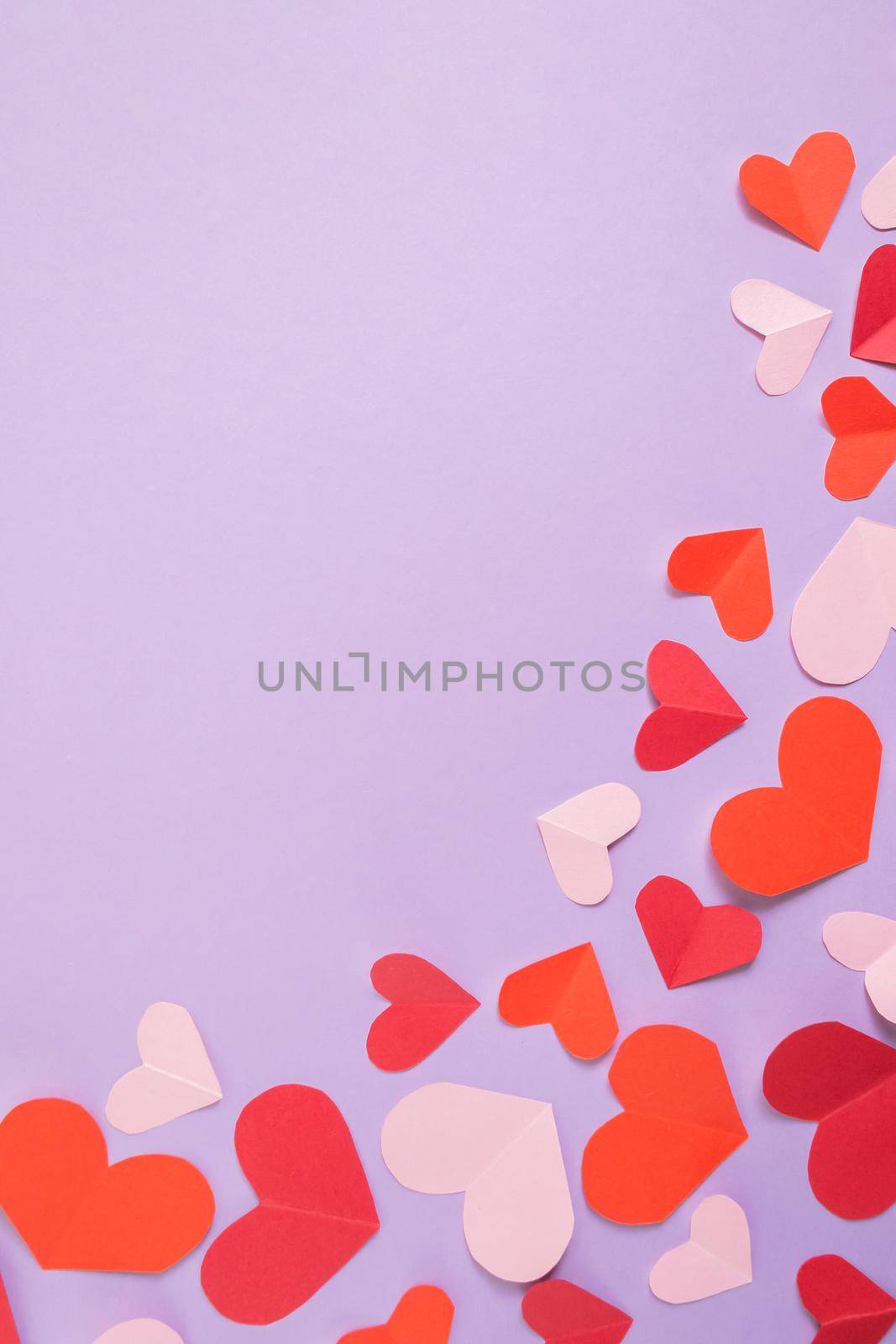 Valentine's Day background. Pink and red hearts on a pastel purple background. Valentine's Day concept. Layout for postcards and congratulations. Flat lay, top view, copy space by Alla_Morozova93