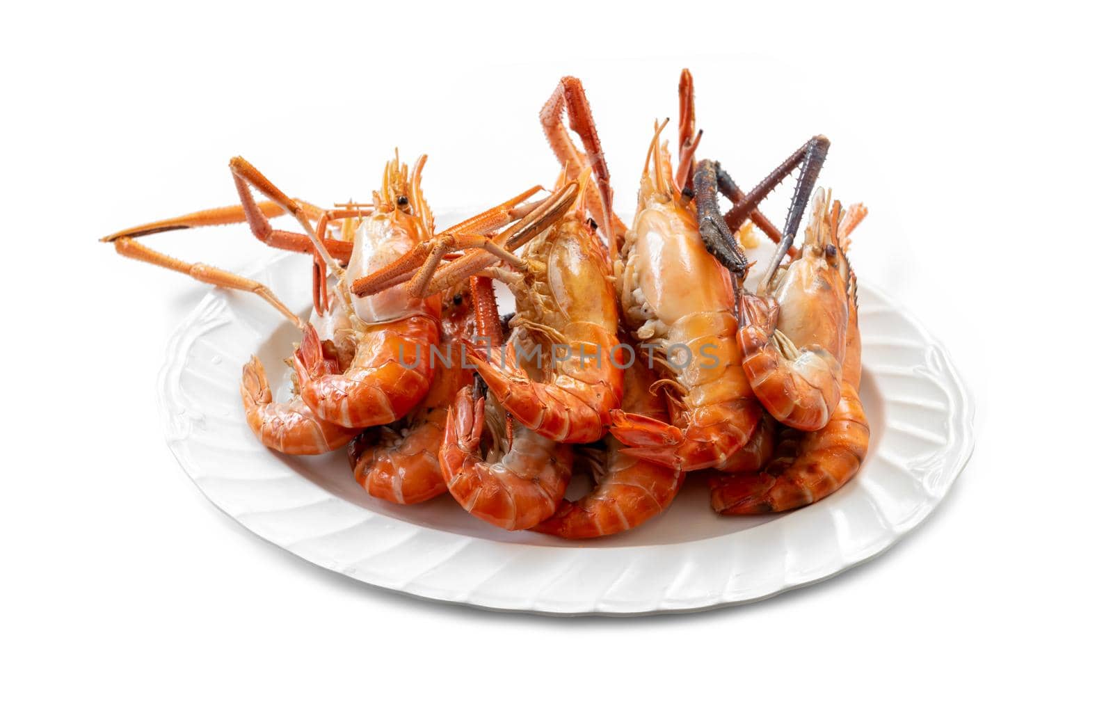 Several large river prawns, grilled and placed on a plate, are ready to eat. by wattanaphob