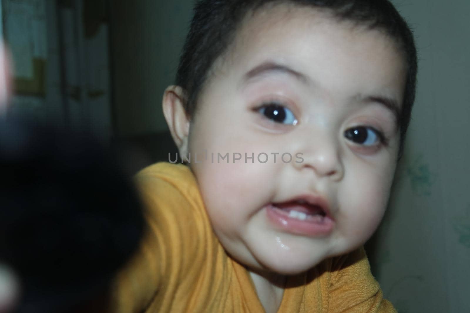Baby girl with lovely face, big eyes and cute face gesture by Photochowk
