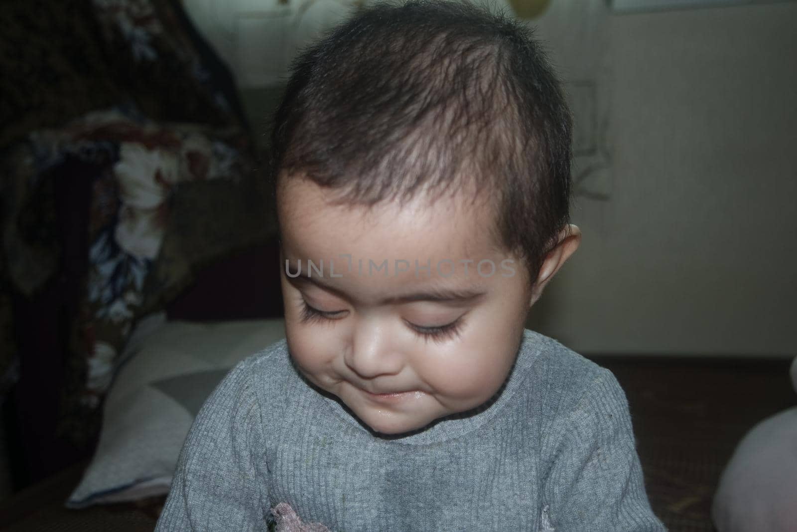 Baby girl with lovely face, big eyes and cute face gesture by Photochowk