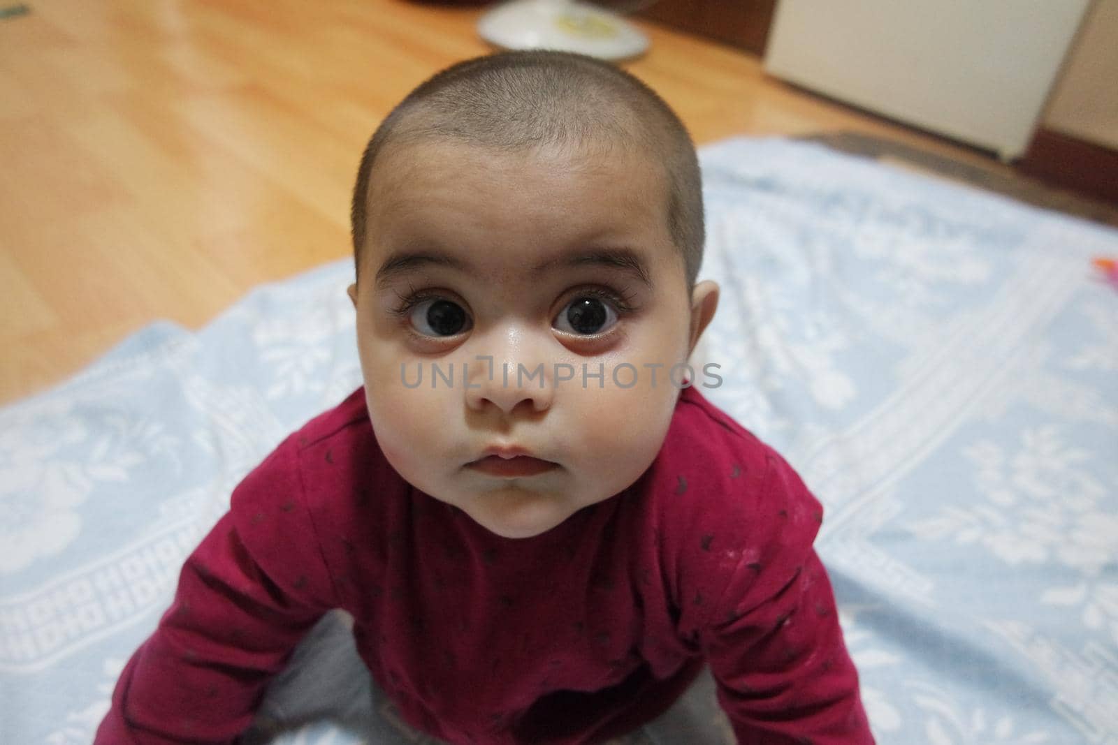 Baby girl with lovely face, big eyes and cute face gesture by Photochowk