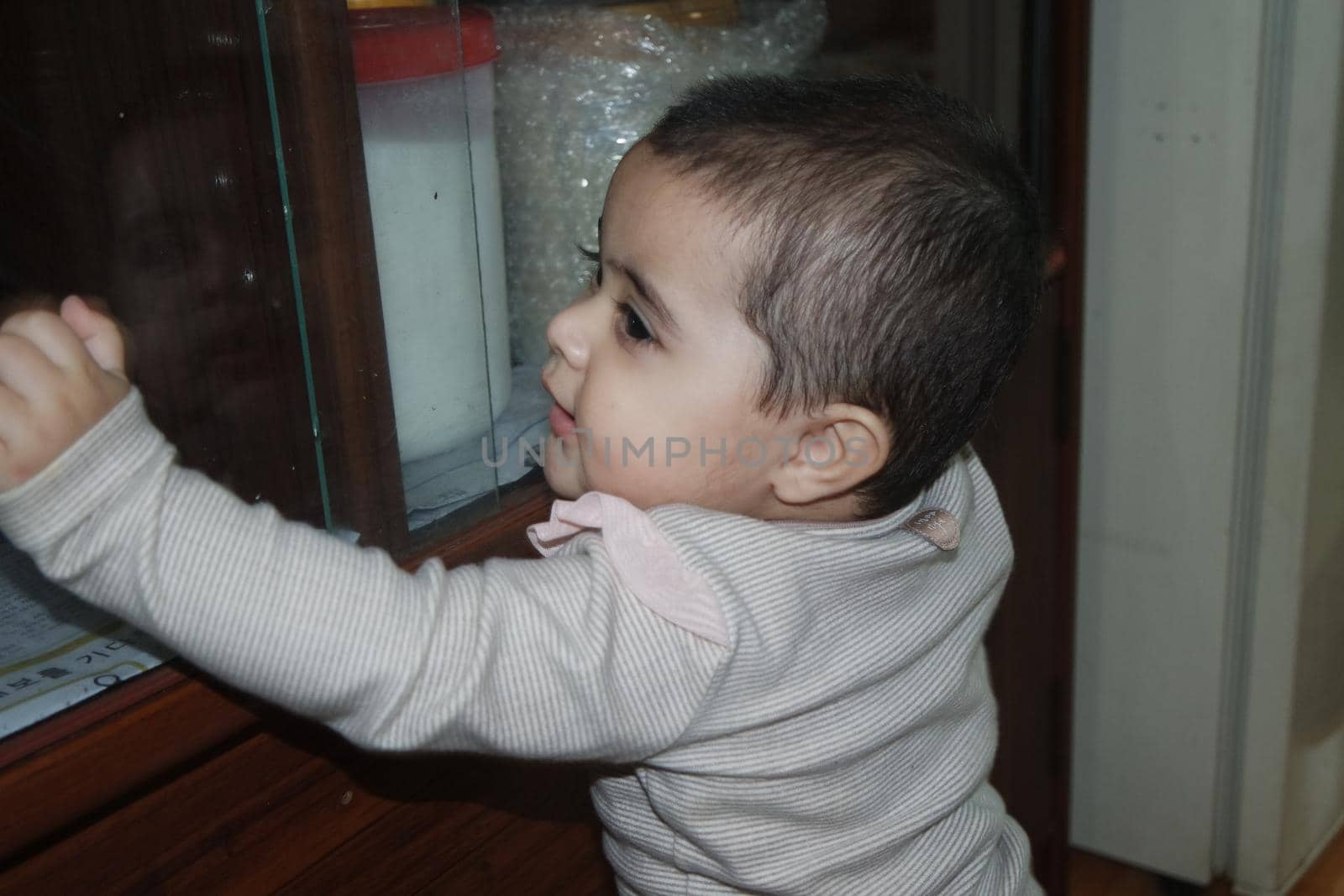 Baby girl with lovely face, big eyes and cute face gesture by Photochowk