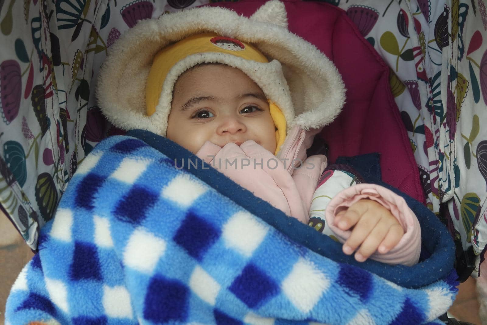 Baby girl with lovely face, big eyes and cute face gesture by Photochowk