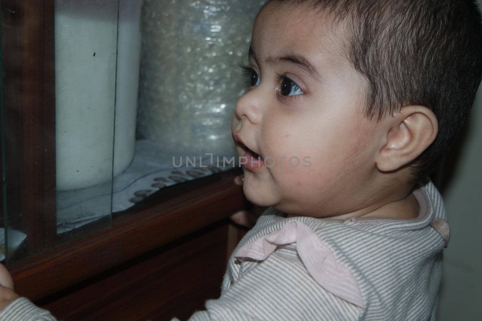 Baby girl with lovely face, big eyes and cute face gesture by Photochowk