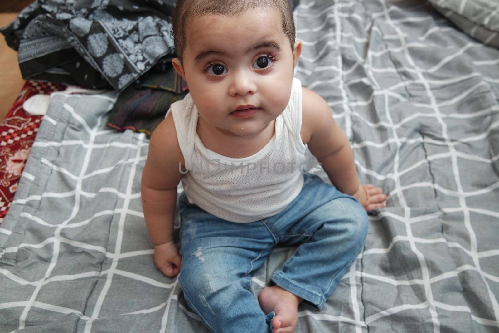 Baby girl with lovely face, big eyes and cute face gesture by Photochowk