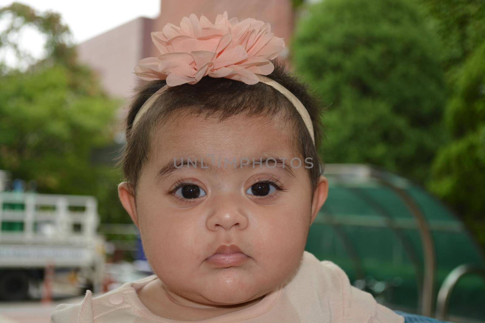 Baby girl with lovely face, big eyes and cute face gesture by Photochowk