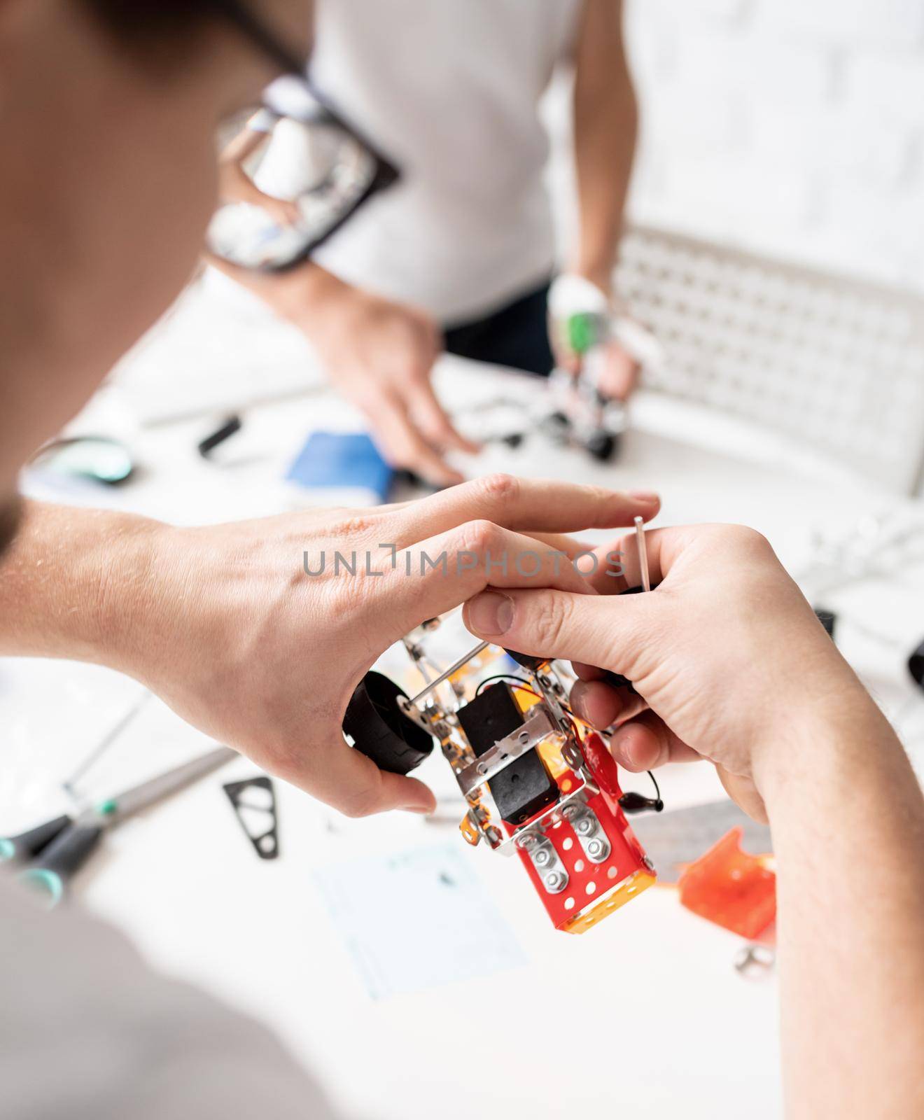 Young boys and having fun constructing robot cars together at the workshop