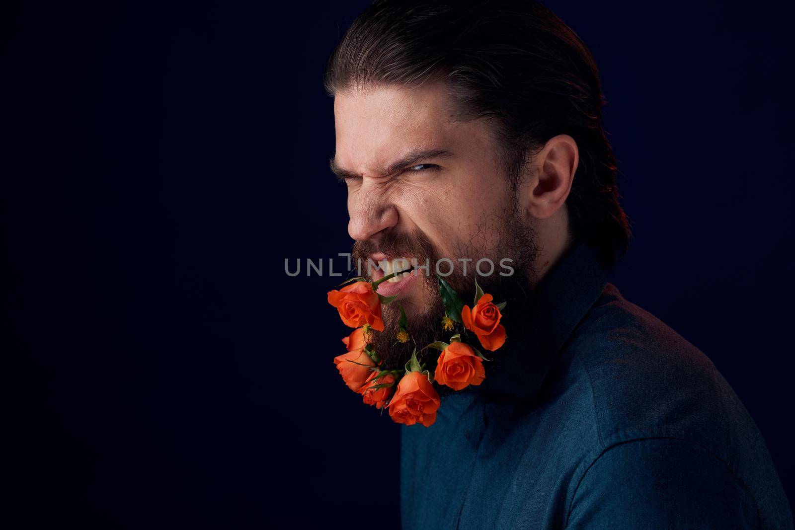 Bearded man holding flowers decoration romance luxury dark background by SHOTPRIME