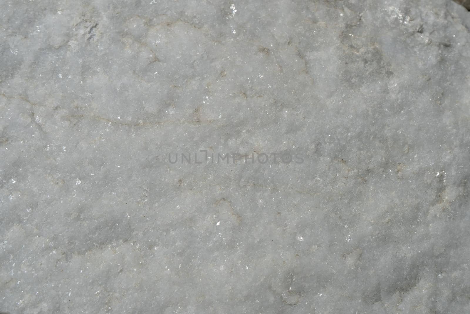 Natural background of light marble with a non-uniform texture.