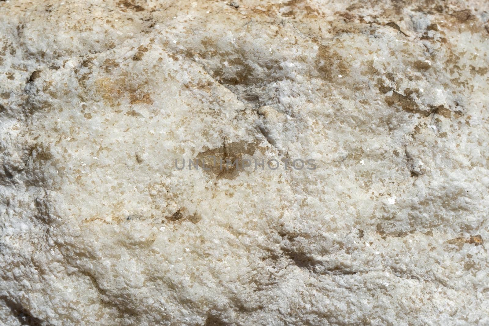Natural background of light marble with a non-uniform texture.