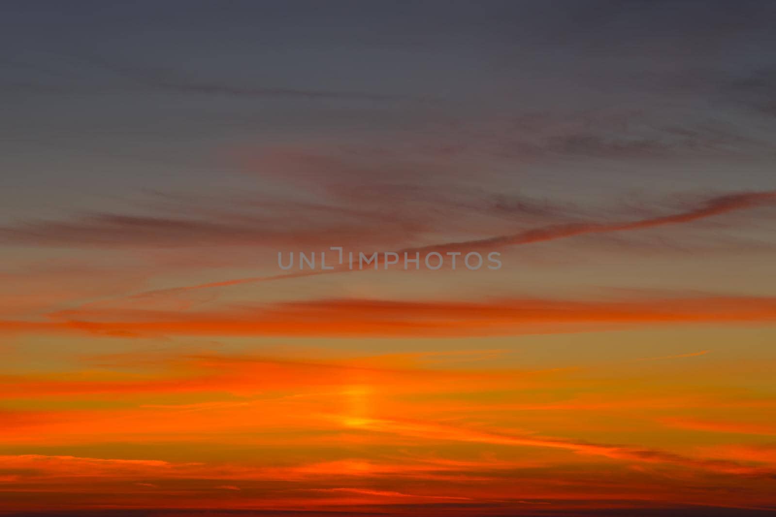 Bright orange-red sunset on a dark blue sky. by Vvicca