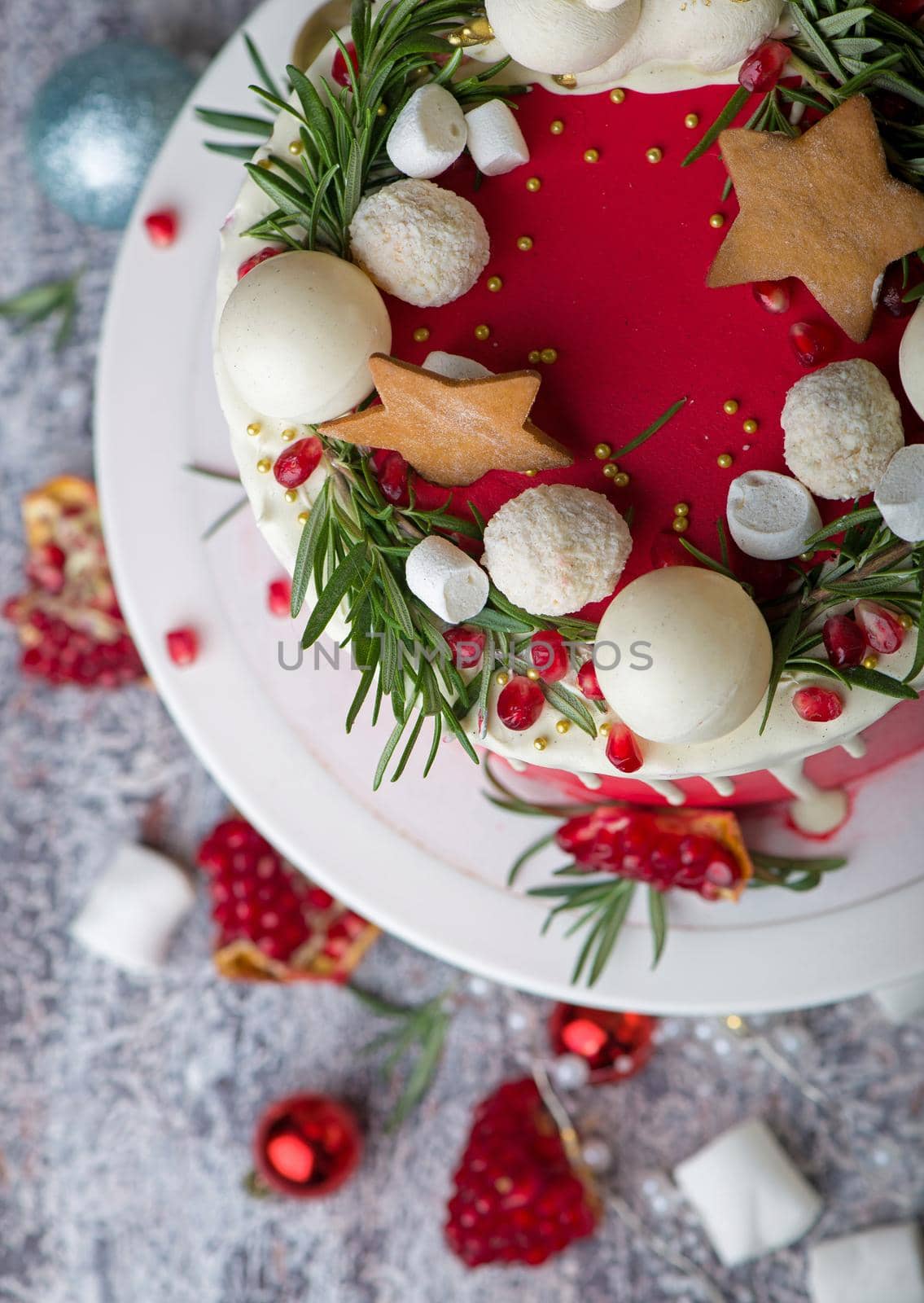 Christmas or New Year decorated cake with cream cheese frosting and cranberries