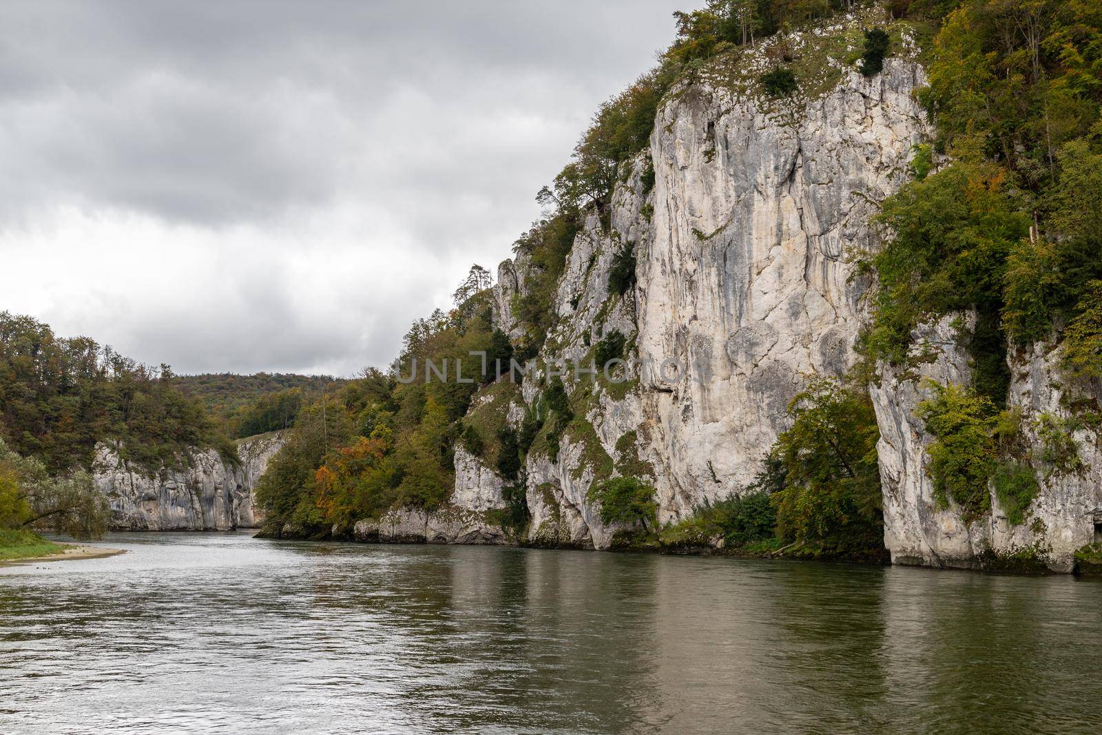 Danube river at Danube breakthrough near Kelheim, Bavaria, Germany in autumn with limestone rock formations and plants with colorful leaves