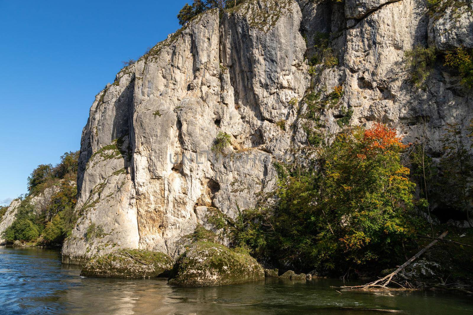 Danube river near Danube breakthrough near Kelheim, Bavaria, Germany in autumn with limestone rock formations and sunny weather with blue sky