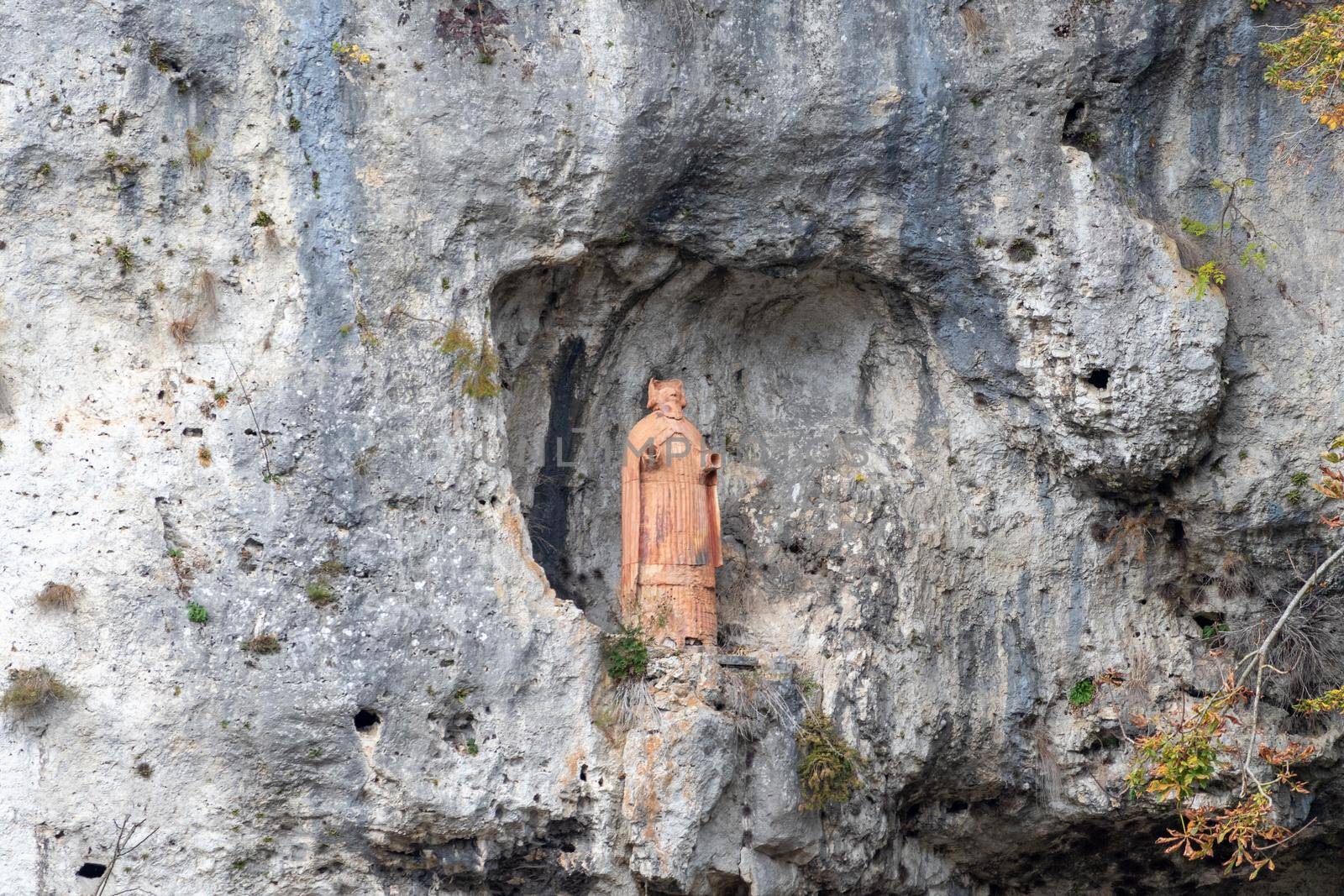 Terracotta statue of St. Nicholas in the rock near franciscan monastery Klösterl near Kelheim, Bavaria, Germany