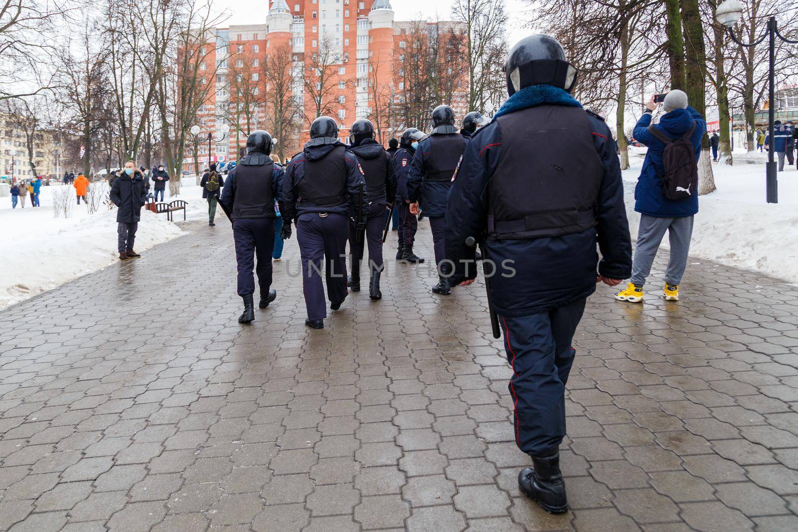 TULA, RUSSIA - JANUARY 23, 2021: Public mass meeting in support of Alexei Navalny, group of police officers going to arrest protesters. by z1b